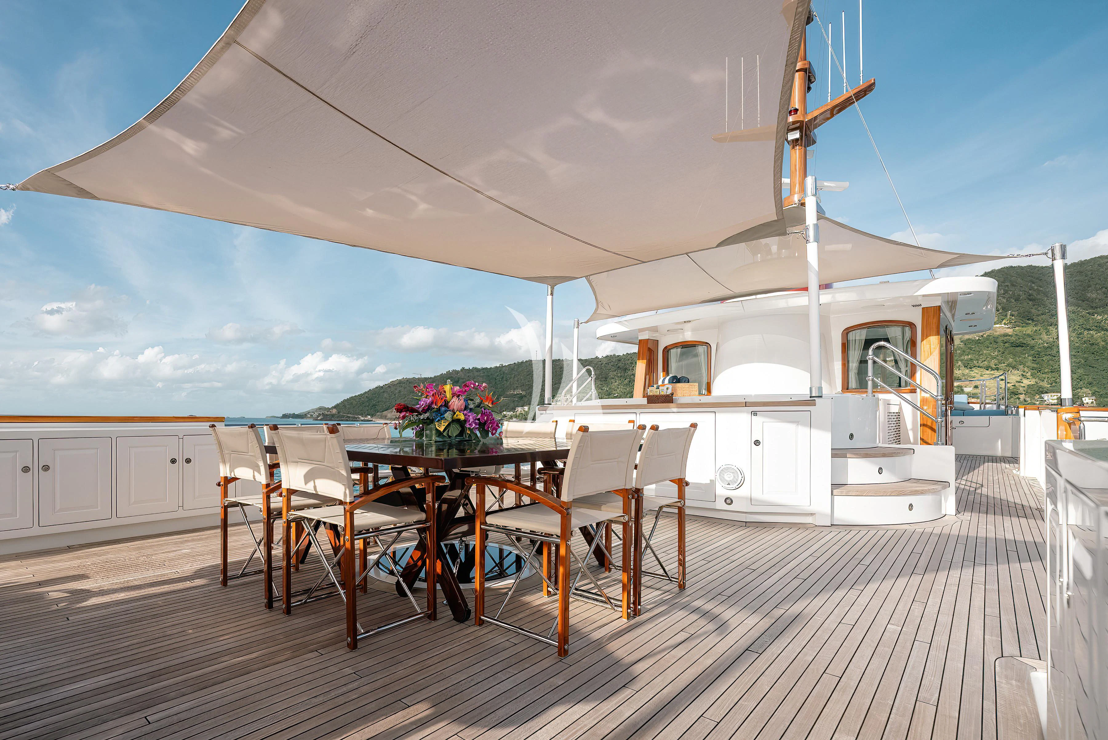 a patio with tables and chairs aboard NADAN Yacht for Sale