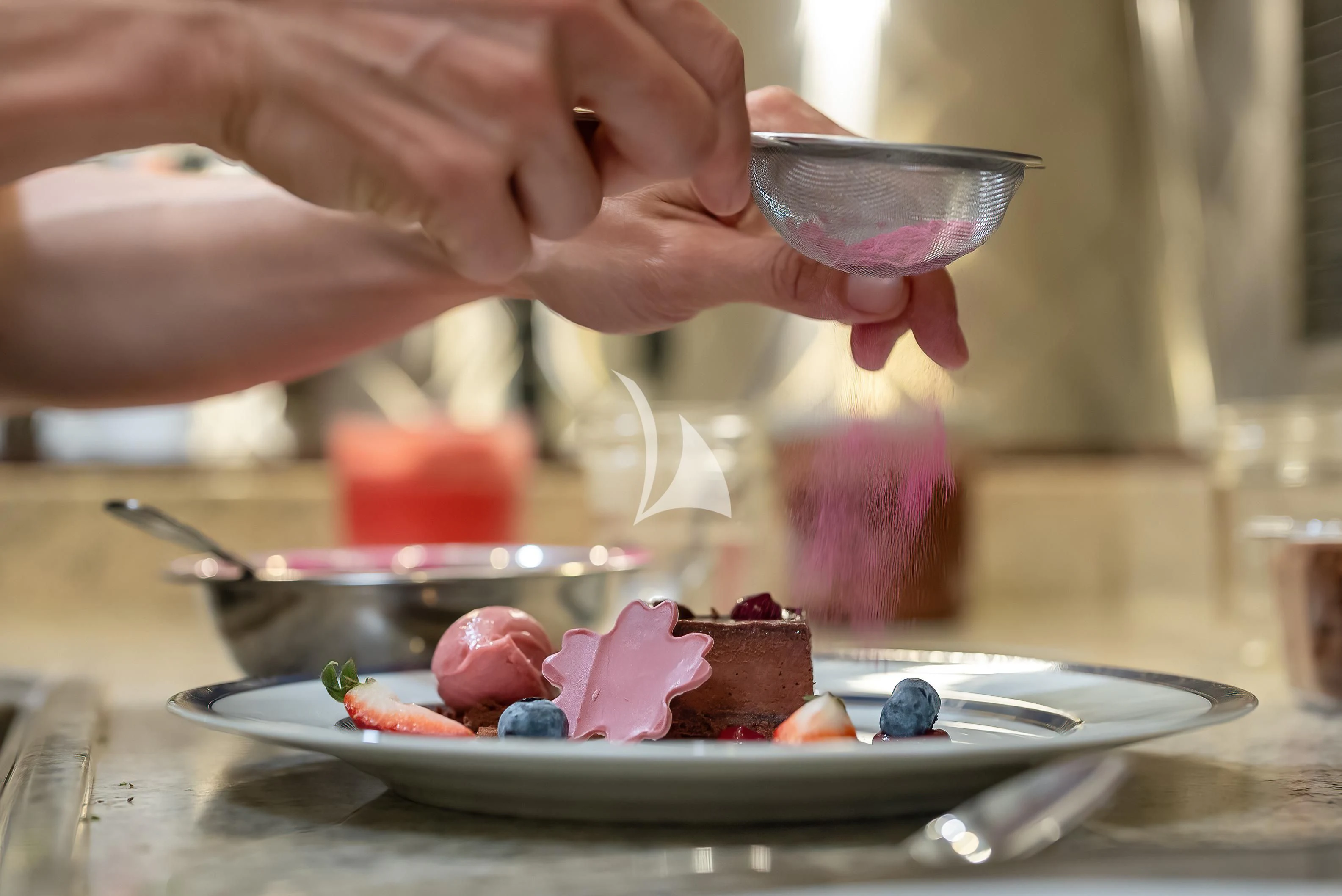 a person pouring a chocolate into a cupcake aboard NADAN Yacht for Sale