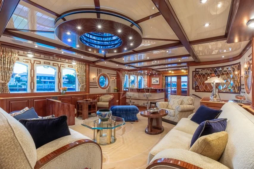 a large living room with a chandelier aboard NADAN Yacht for Sale