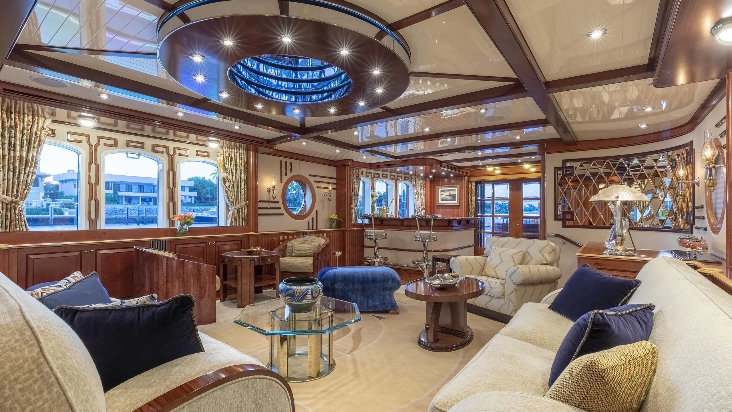 a large living room with a large chandelier aboard NADAN Yacht for Sale