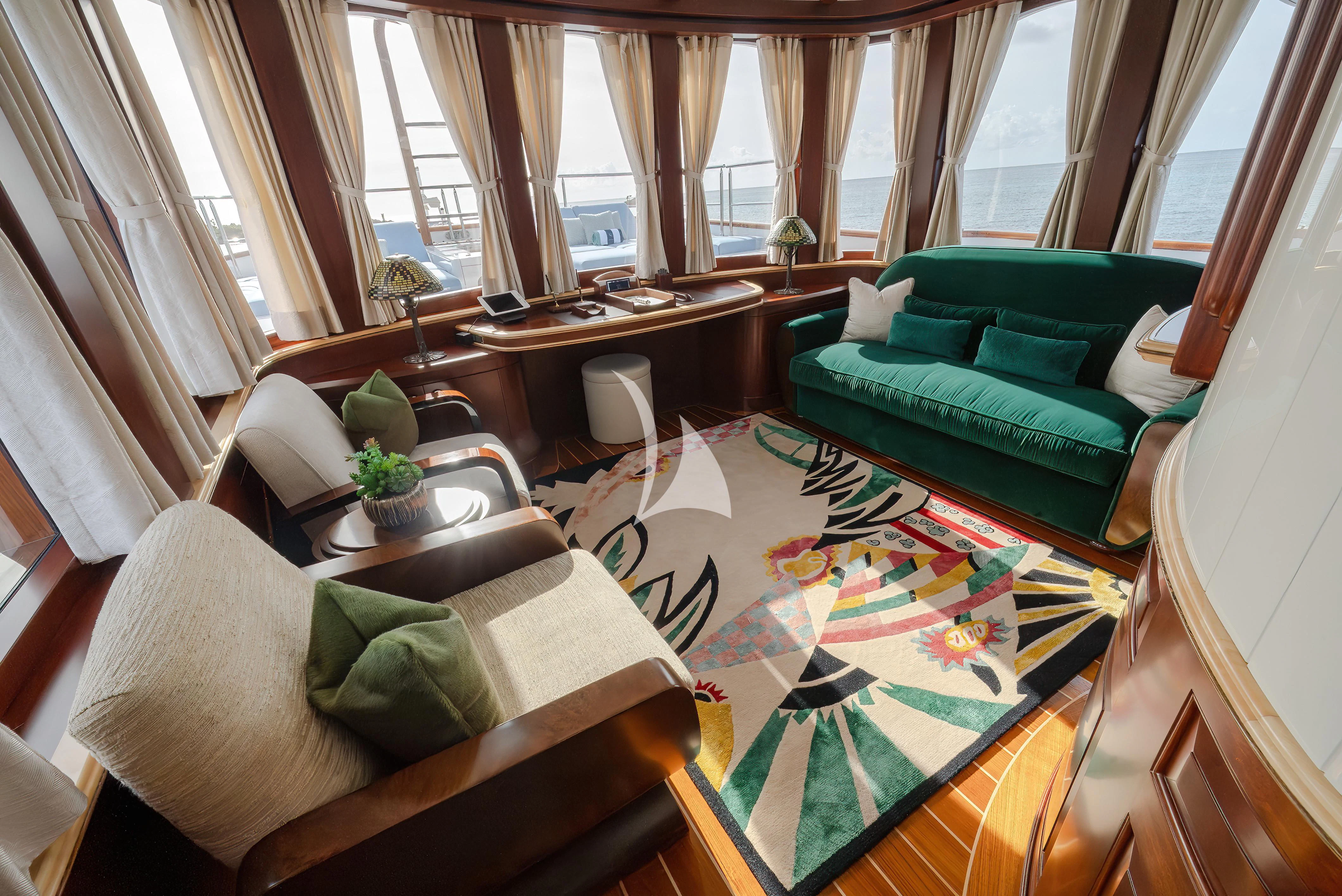 a living room with a couch and a table aboard NADAN Yacht for Sale