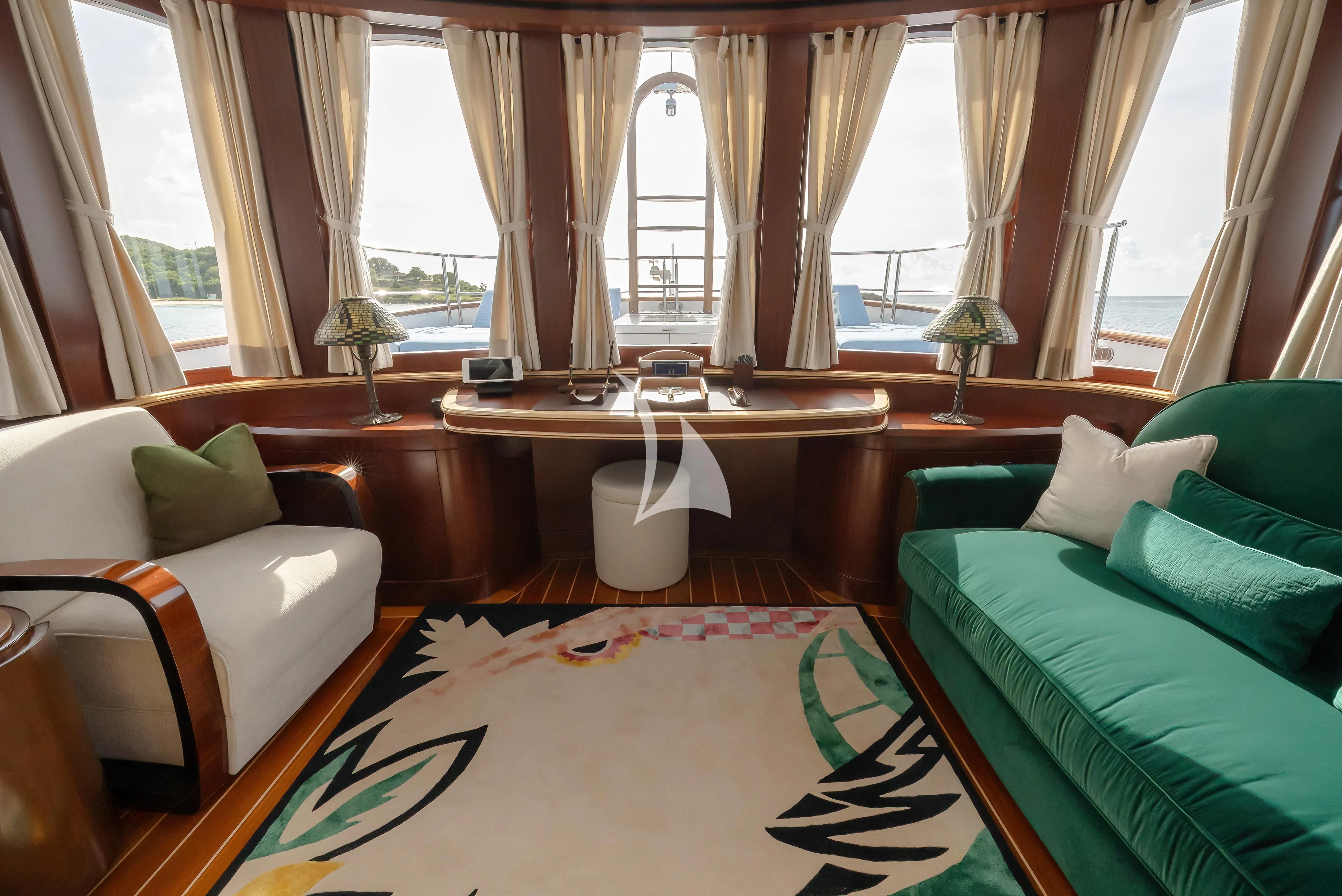 a living room with a couch and a table aboard NADAN Yacht for Sale