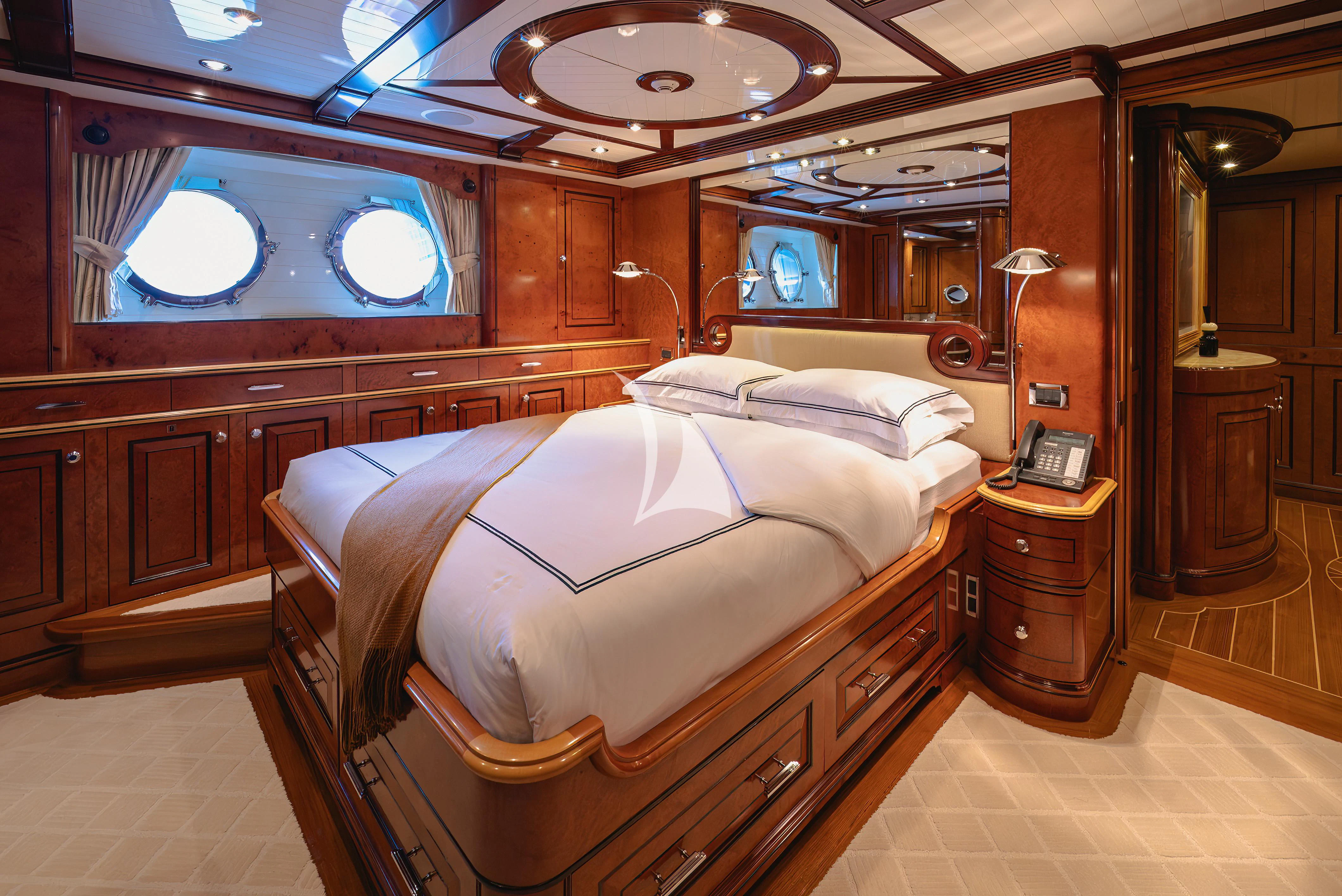 a room with a bed and a desk aboard NADAN Yacht for Sale