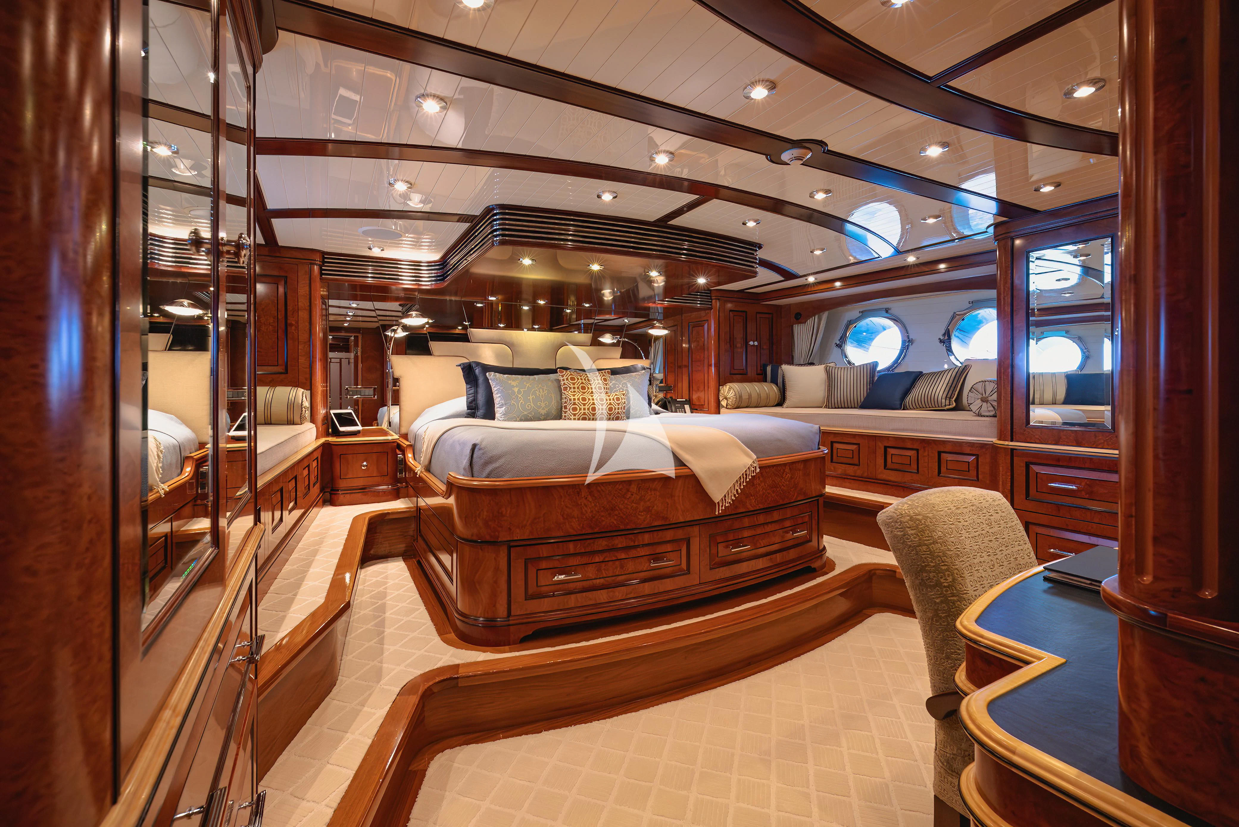 a room with a bed and a couch aboard NADAN Yacht for Sale