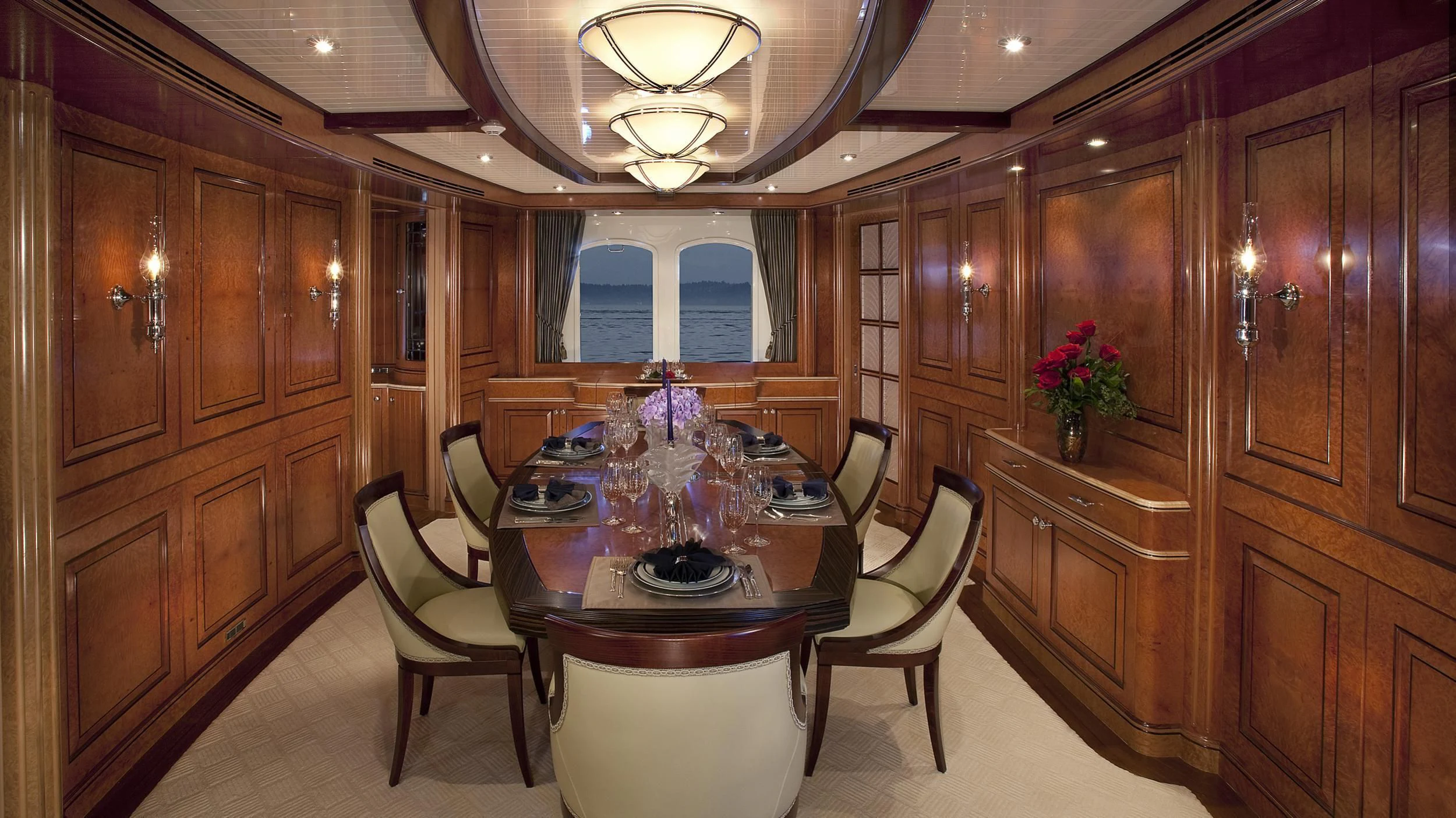 a dining room with a table and chairs aboard NADAN Yacht for Sale