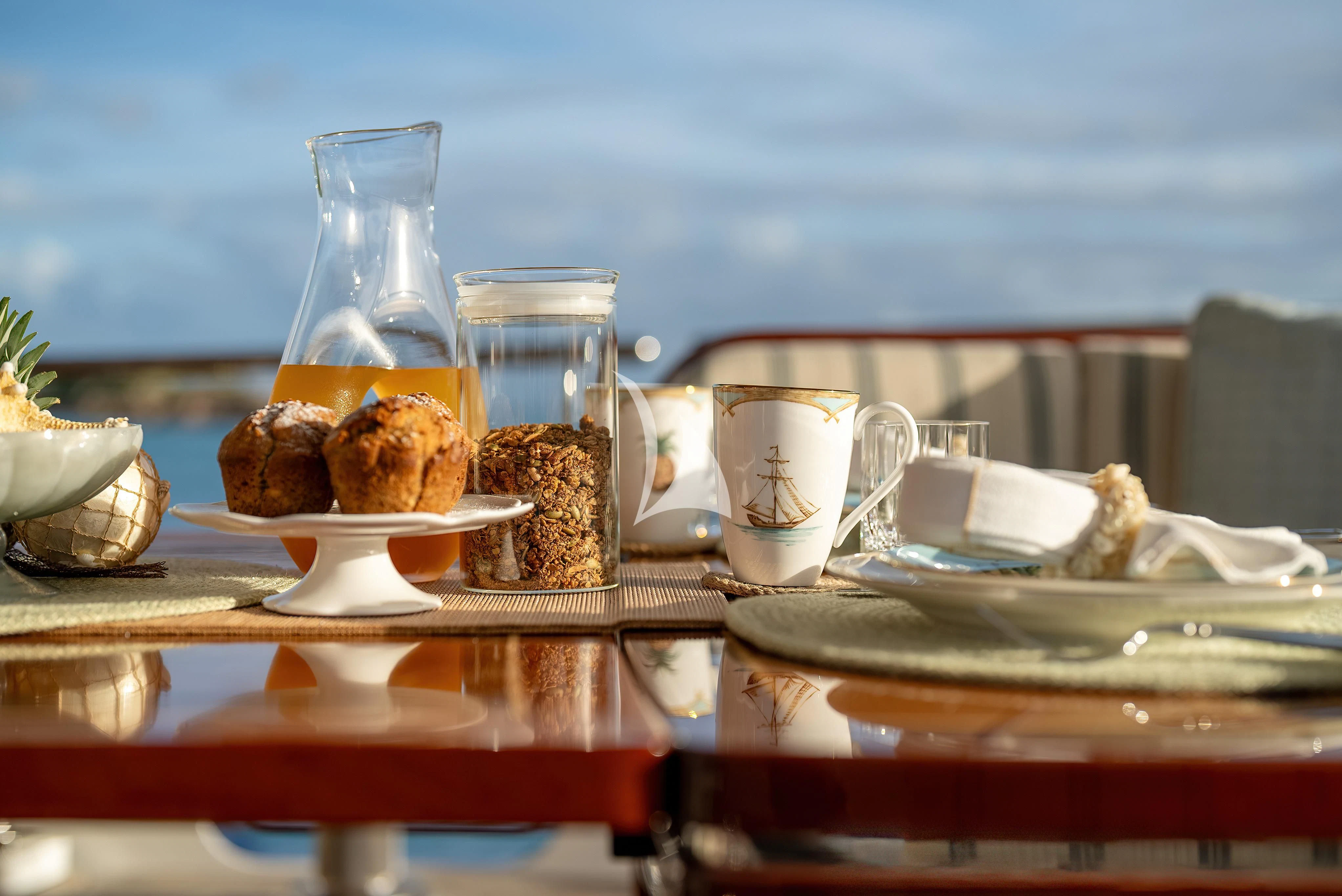 a table with food and glasses on it aboard NADAN Yacht for Sale