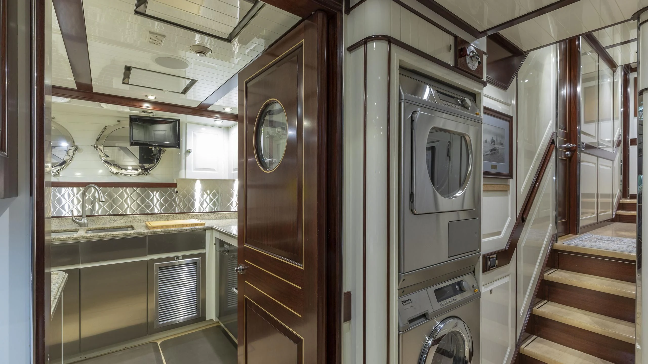 a kitchen with a microwave oven and a stove aboard NADAN Yacht for Sale