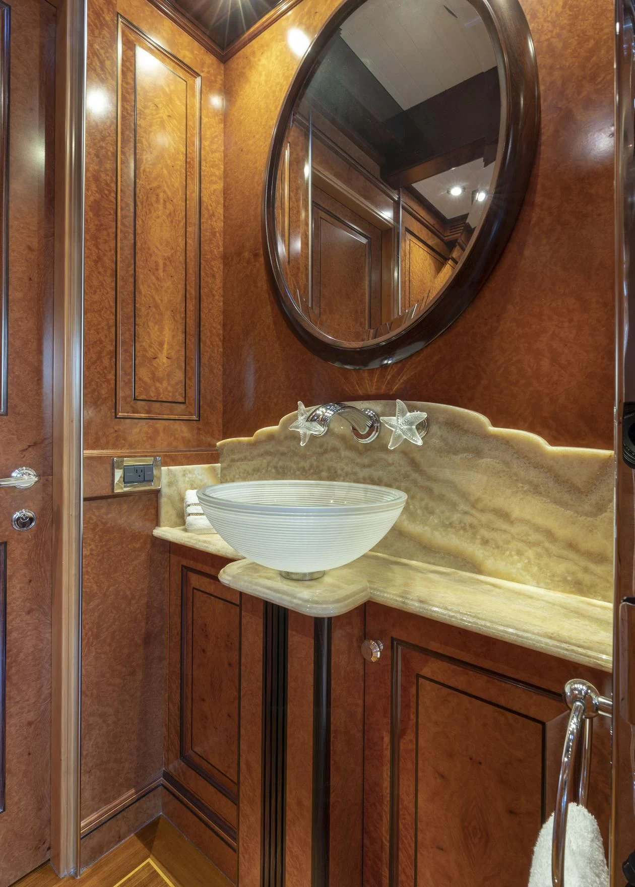 a bathroom with a round mirror aboard NADAN Yacht for Sale