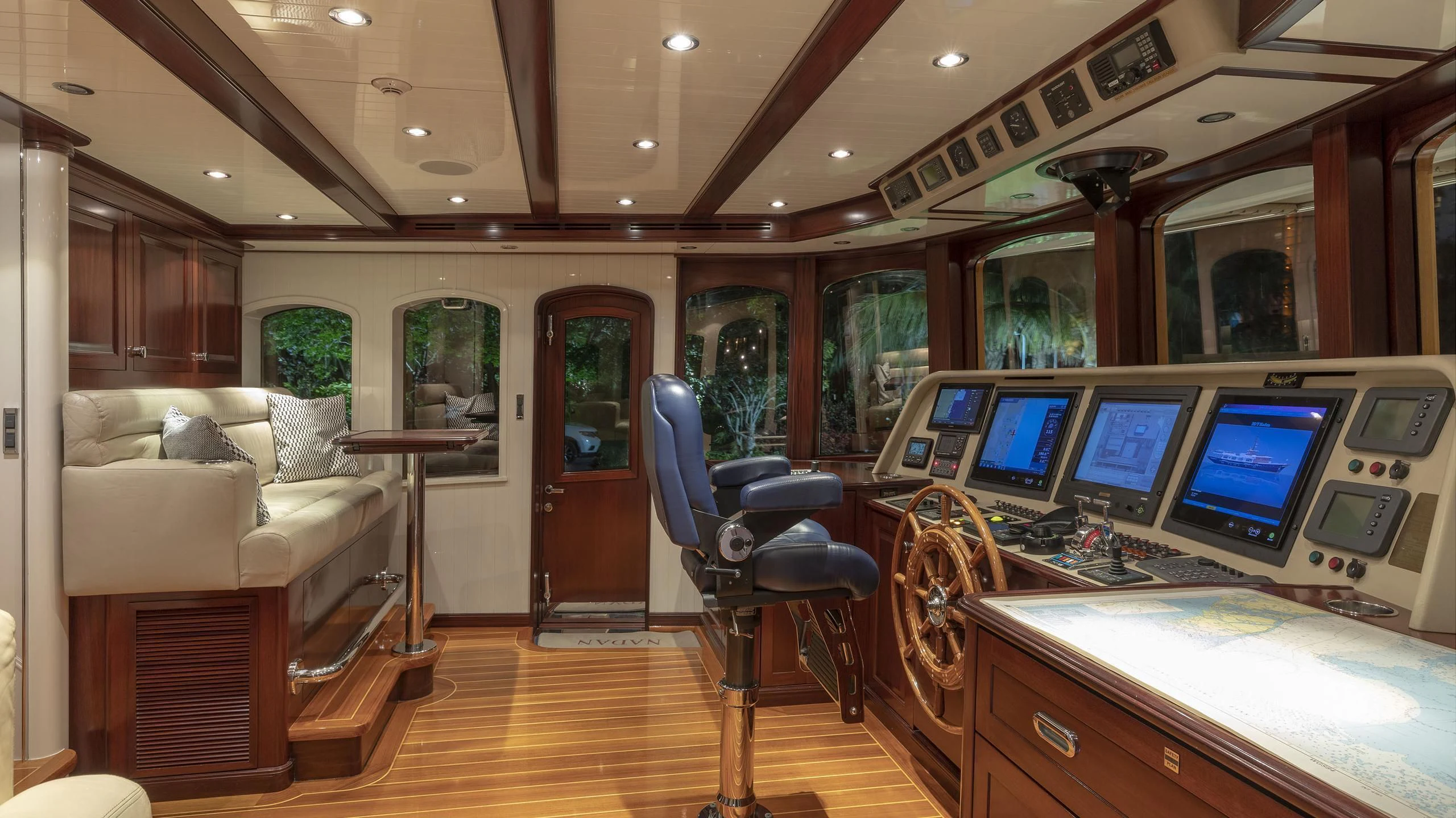 a room with a table chairs and a large window with a large screen aboard NADAN Yacht for Sale