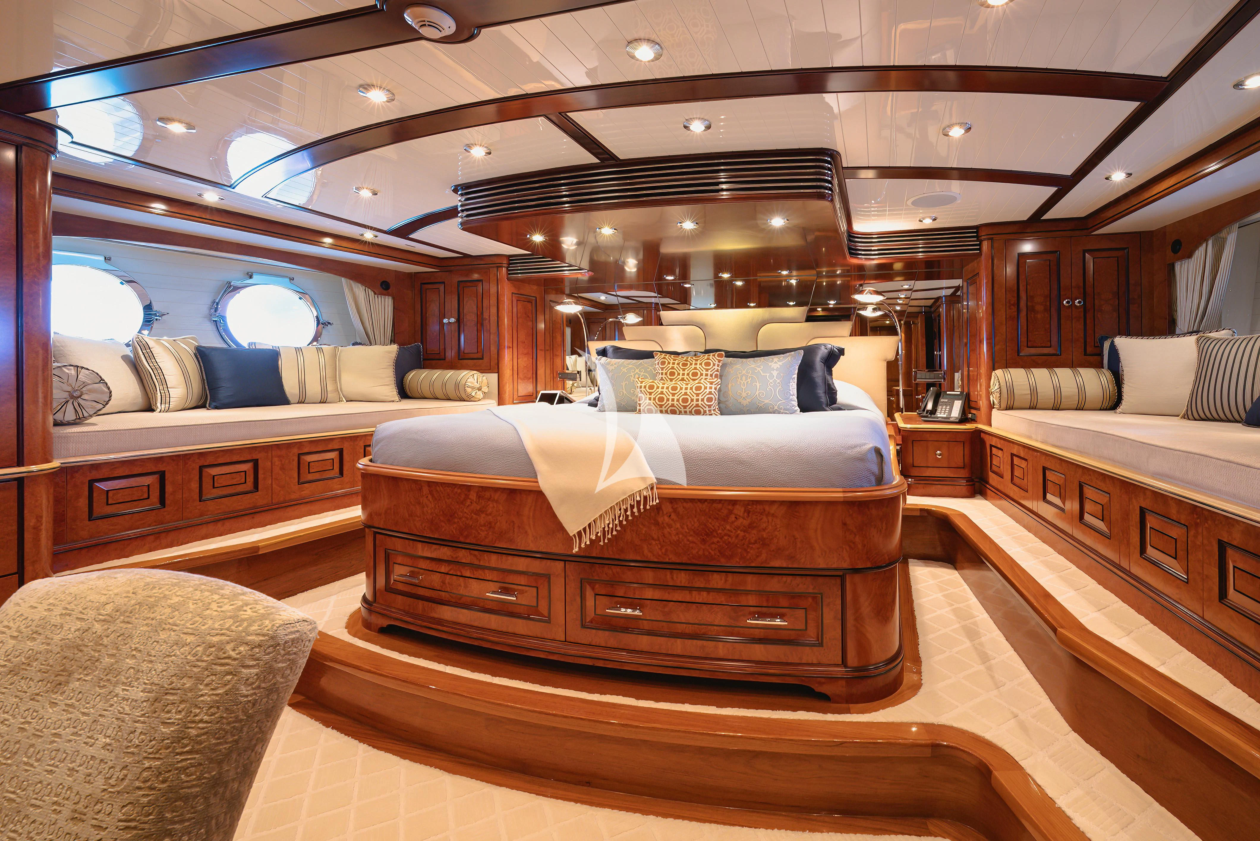 a room with a bed and a couch aboard NADAN Yacht for Sale