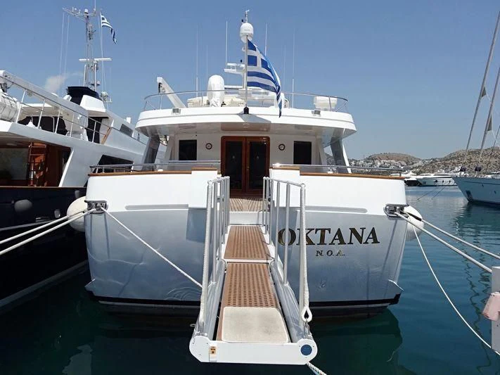 a boat docked at a pier aboard OKTANA Yacht for Sale