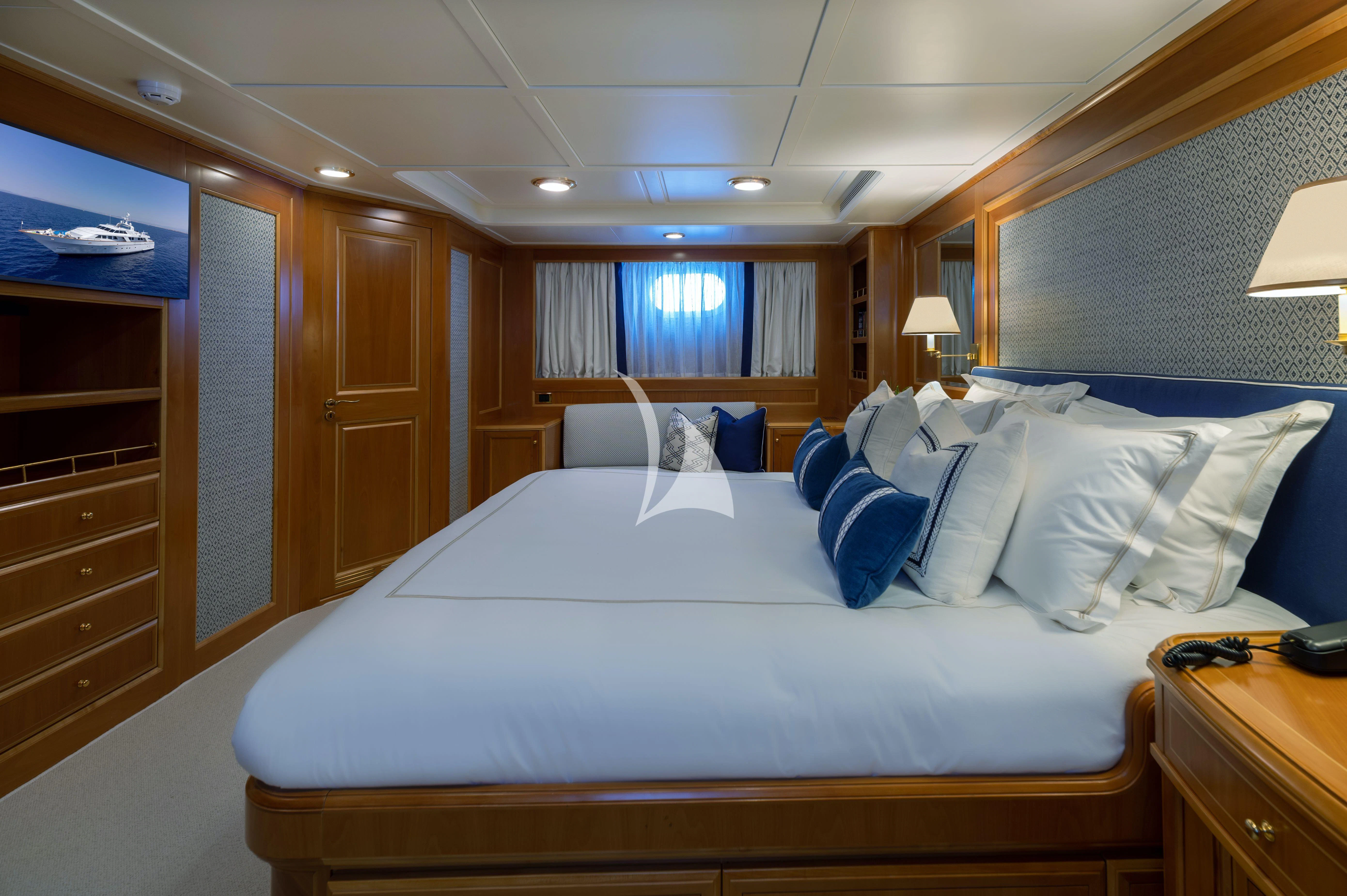 a bed with white sheets and pillows aboard OKTANA Yacht for Sale