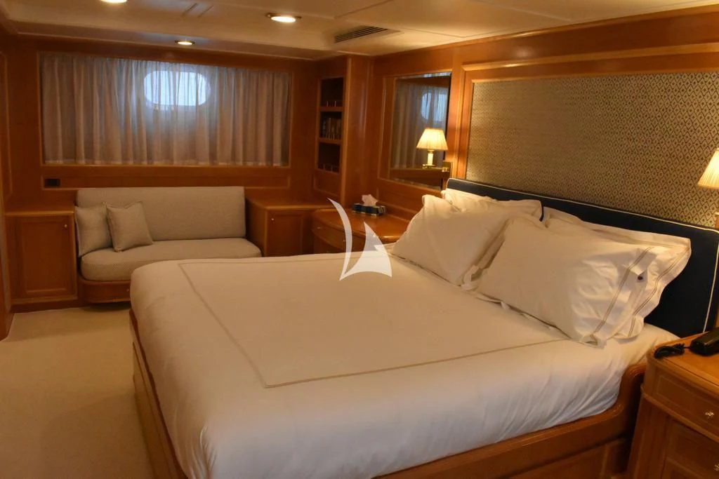 a hotel room with a bed and a couch aboard OKTANA Yacht for Sale
