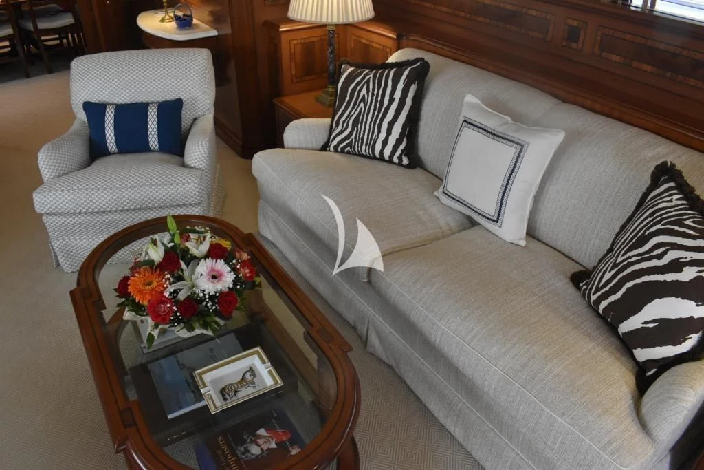 a living room with a couch and a coffee table aboard OKTANA Yacht for Sale