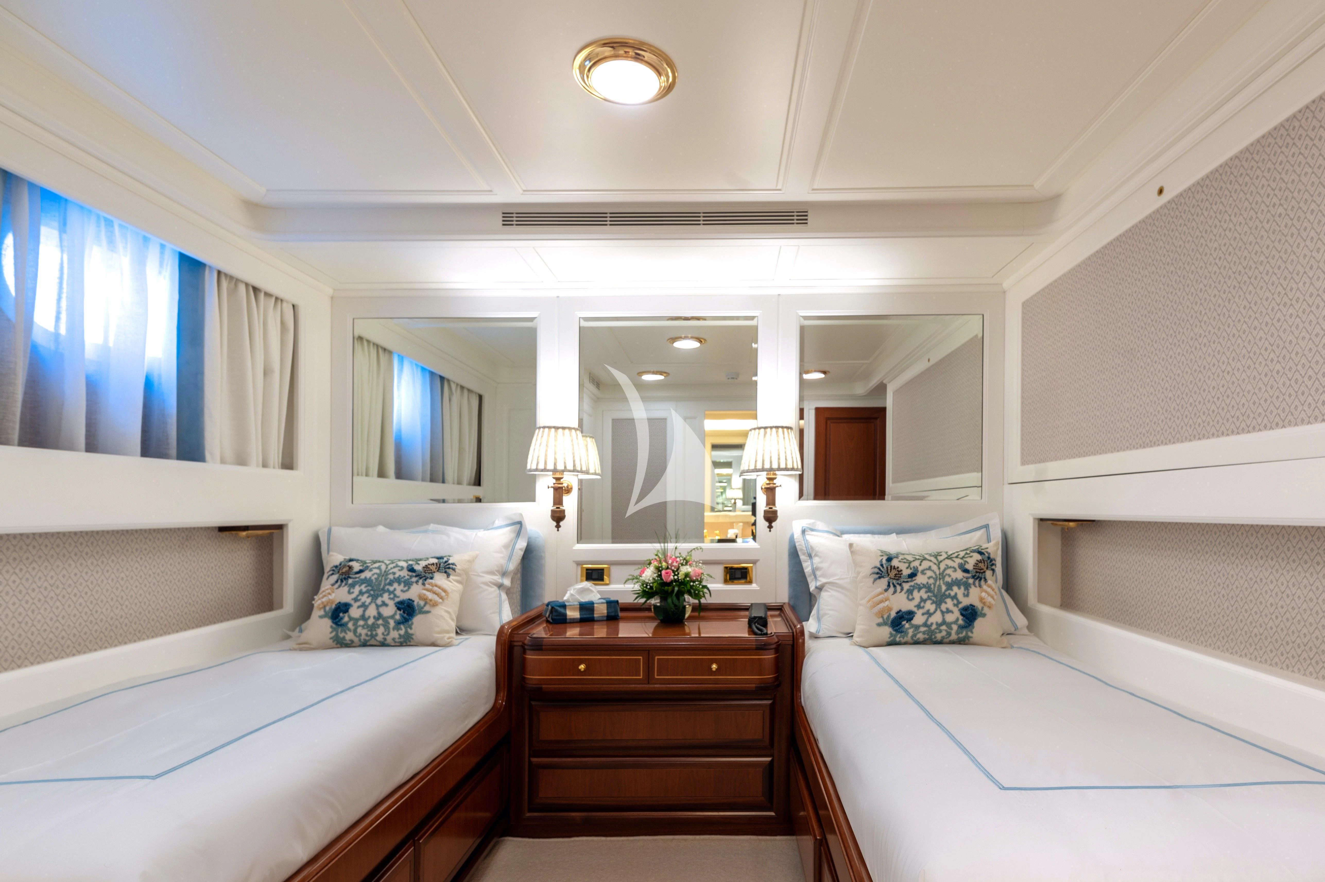 a room with a bed and a mirror aboard OKTANA Yacht for Sale