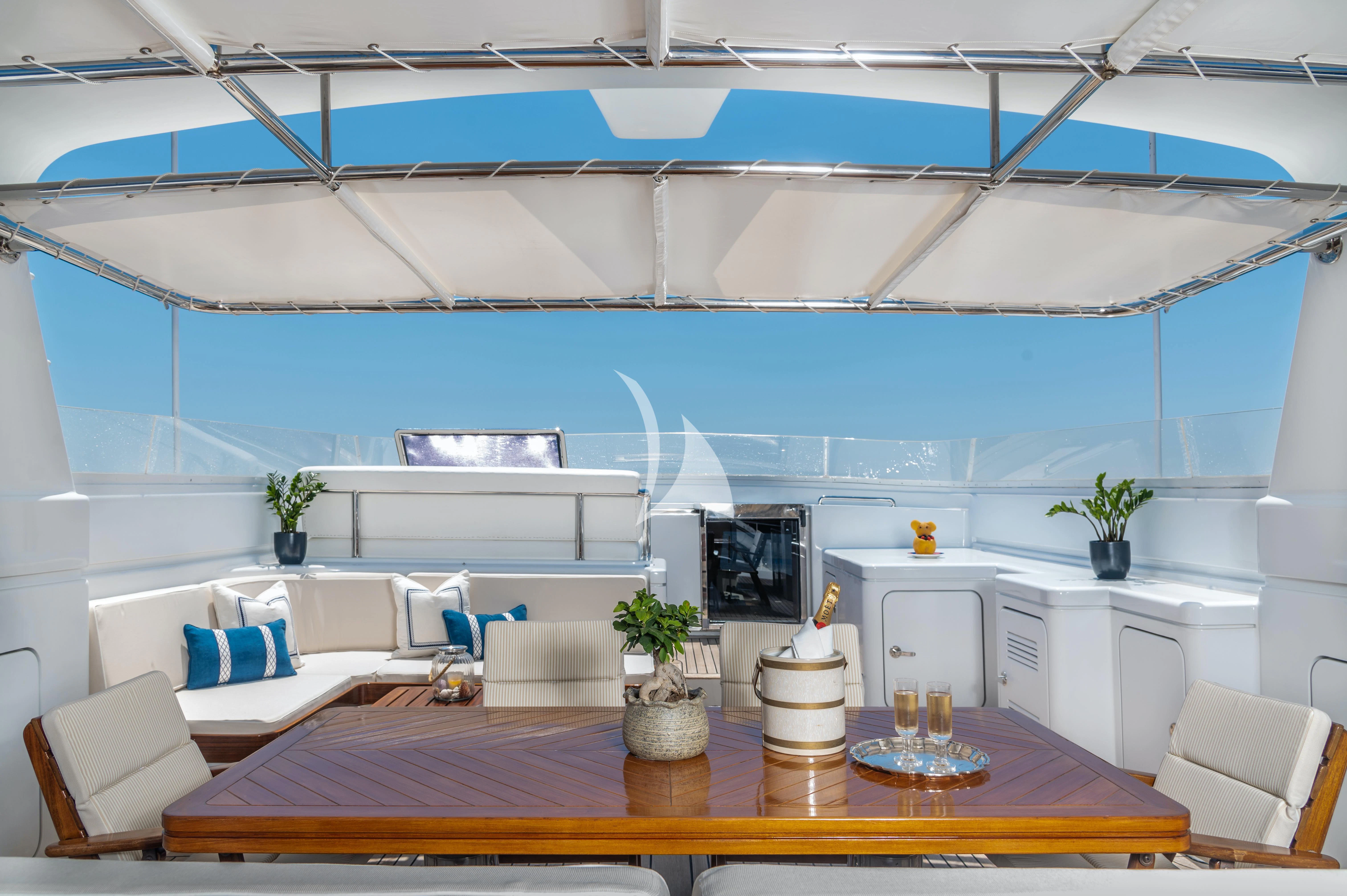 a room with a table and chairs aboard OKTANA Yacht for Sale