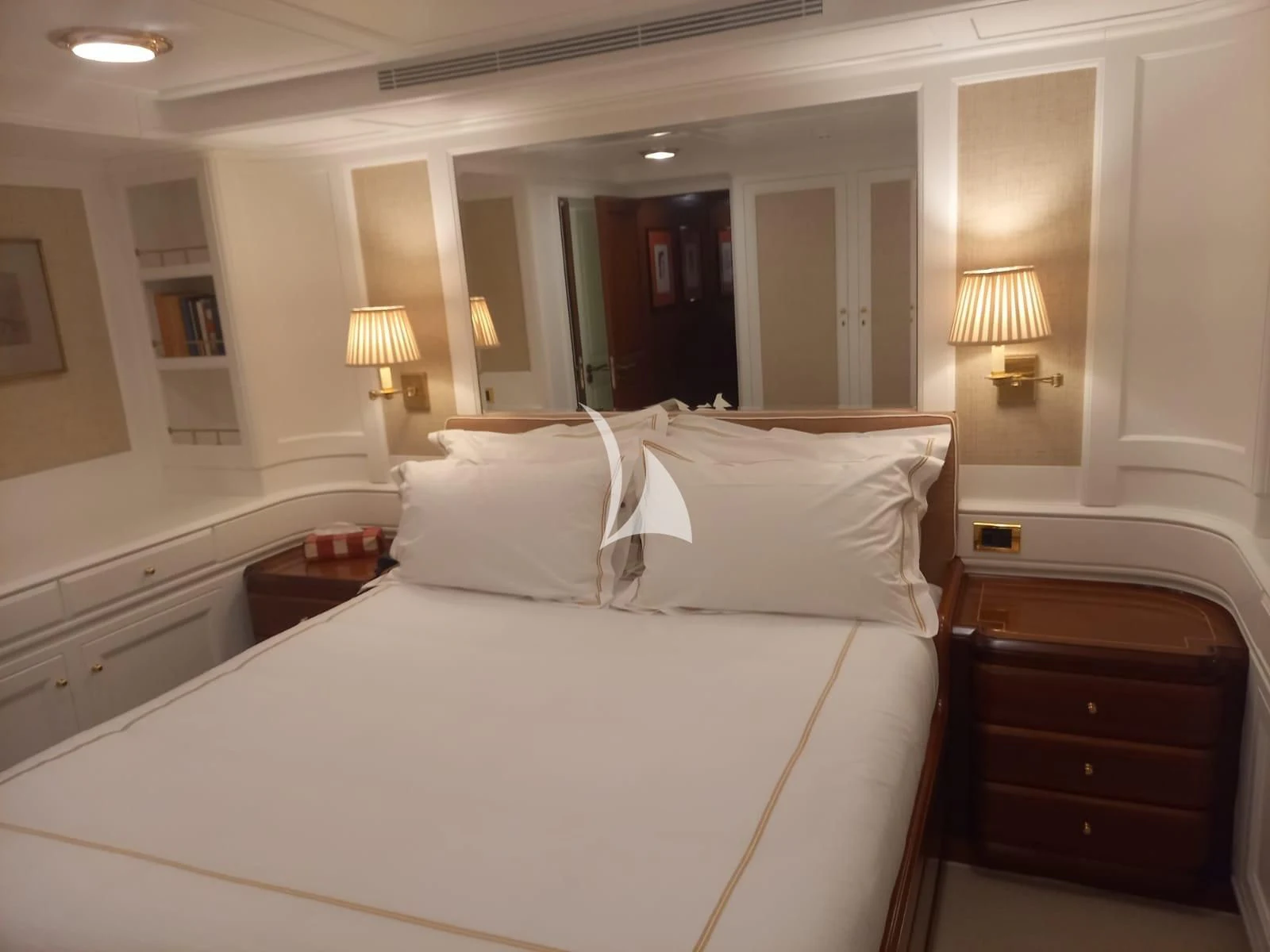 a hotel room with a bed and lamps aboard OKTANA Yacht for Sale