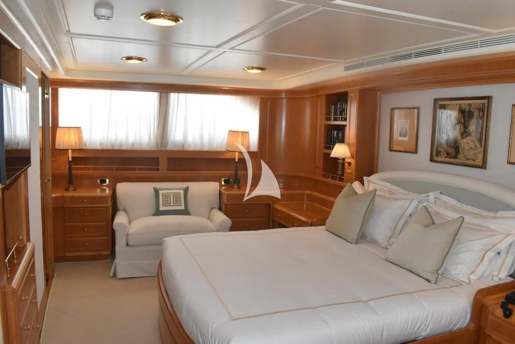 a bedroom with a bed and a couch aboard OKTANA Yacht for Sale