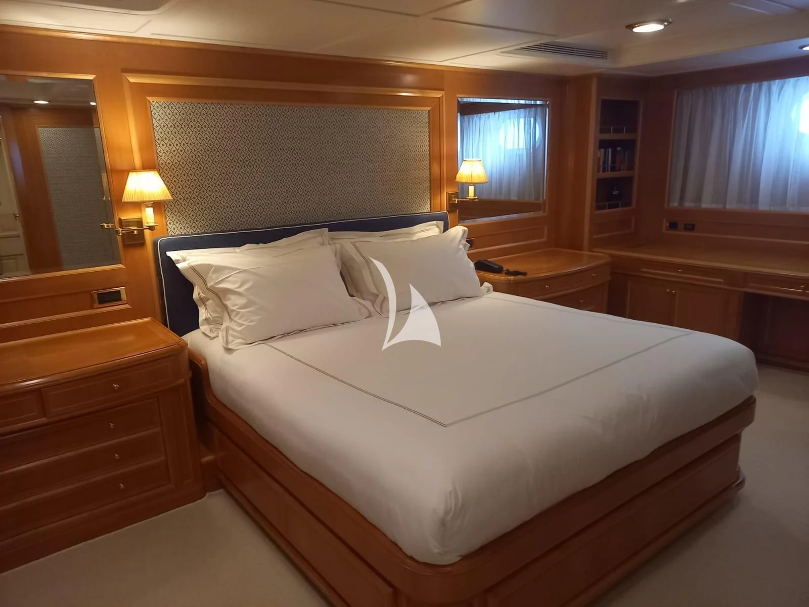 a bed with a white comforter aboard OKTANA Yacht for Sale