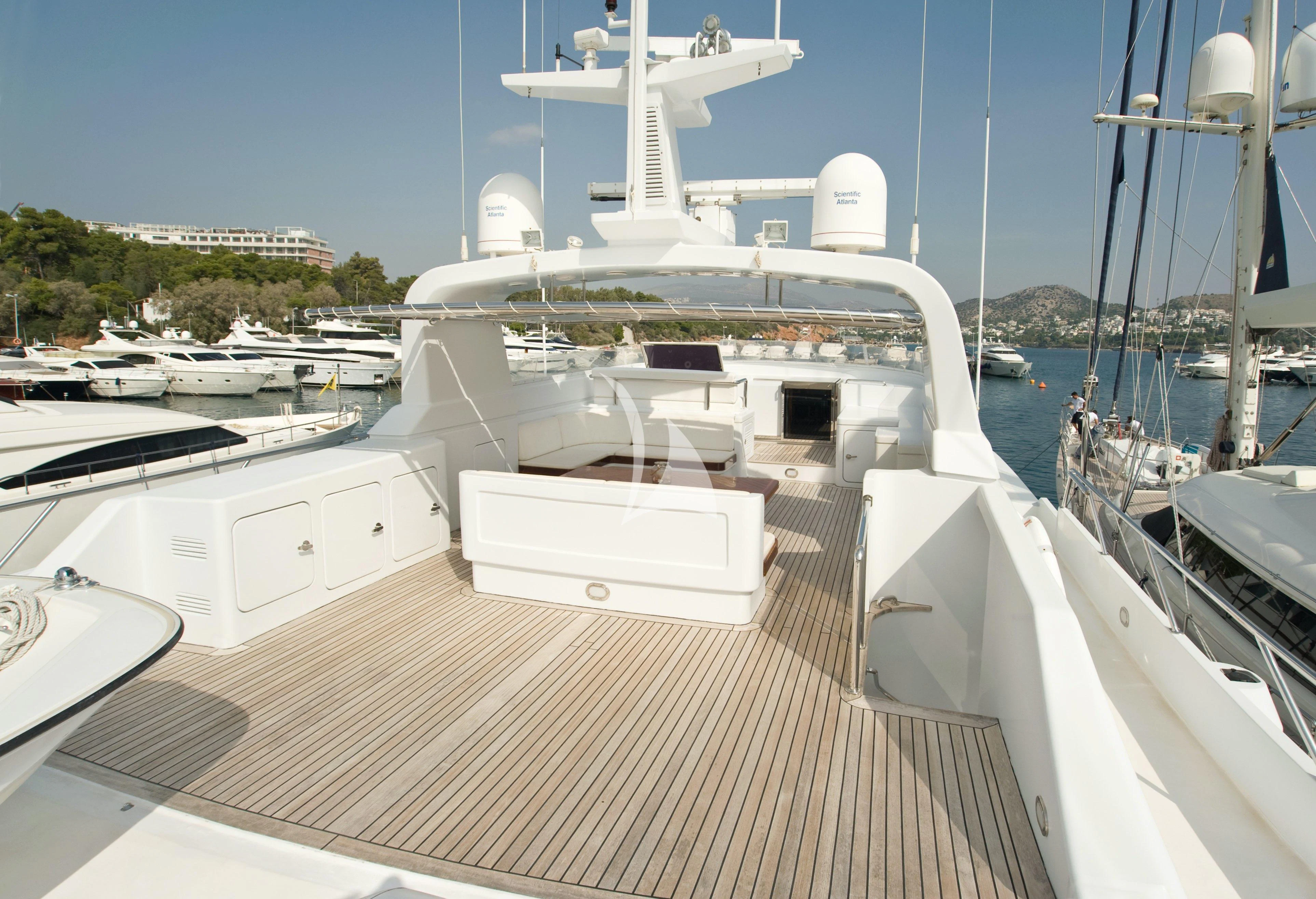 a large white boat in a harbor aboard OKTANA Yacht for Sale