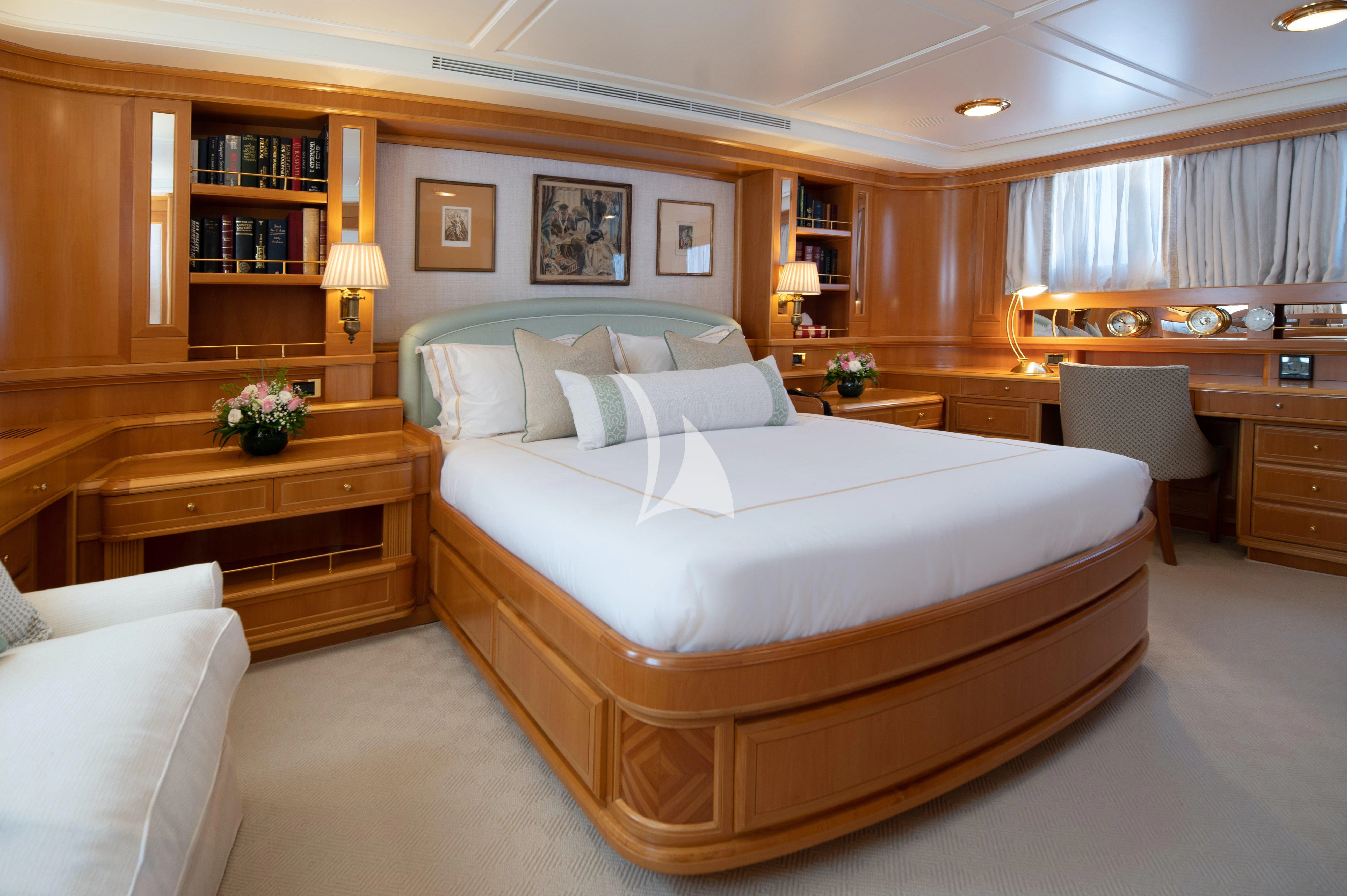 a large bed in a room aboard OKTANA Yacht for Sale