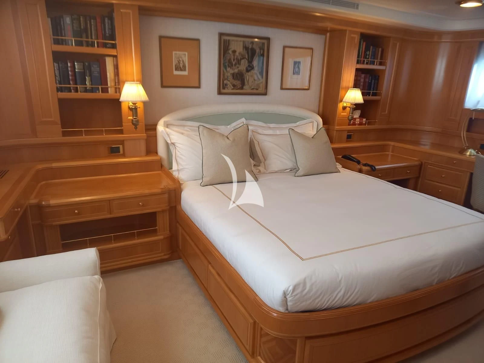 a bed with a white sheet and pillows aboard OKTANA Yacht for Sale