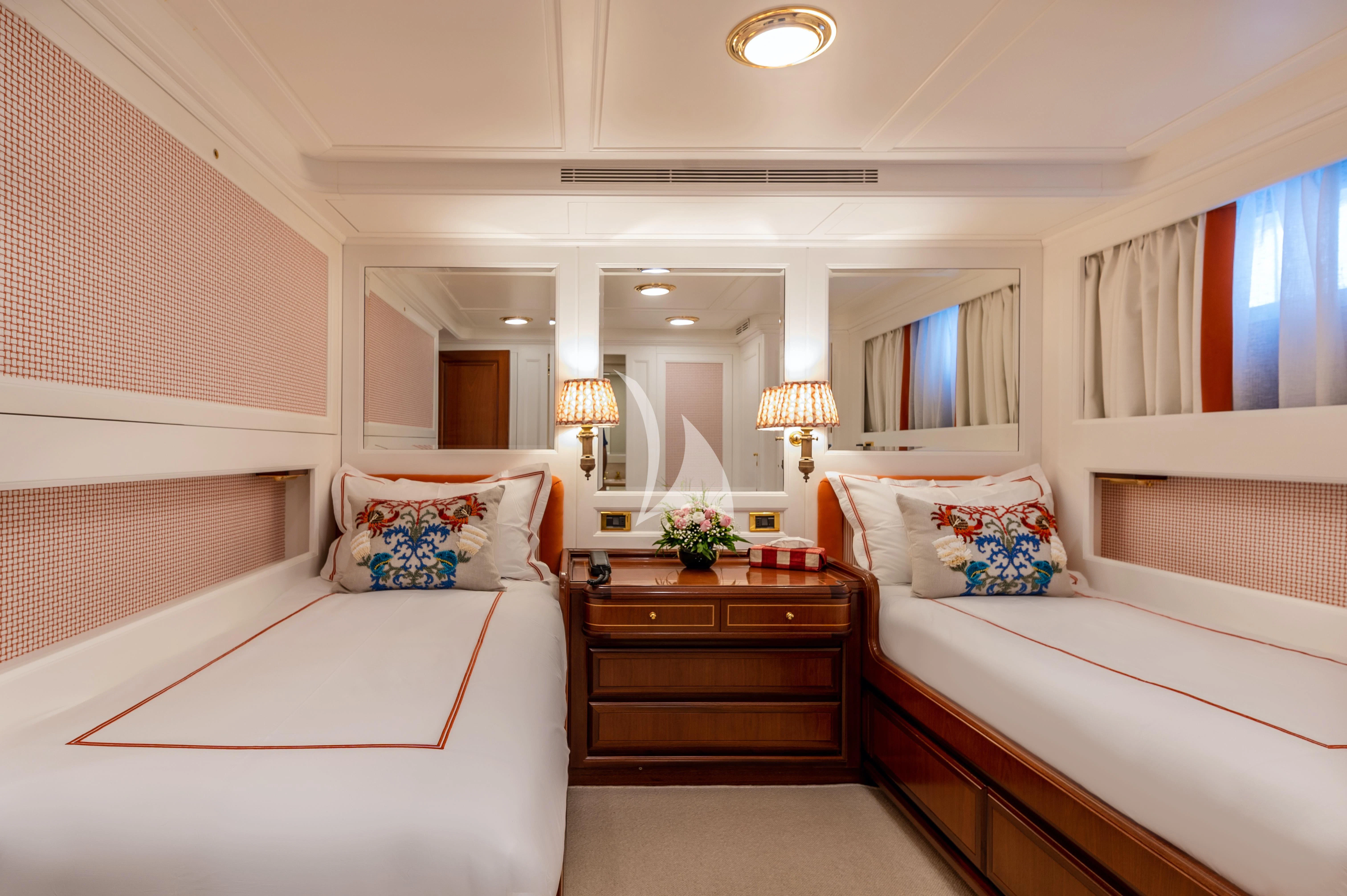 a room with a couple of beds aboard OKTANA Yacht for Sale