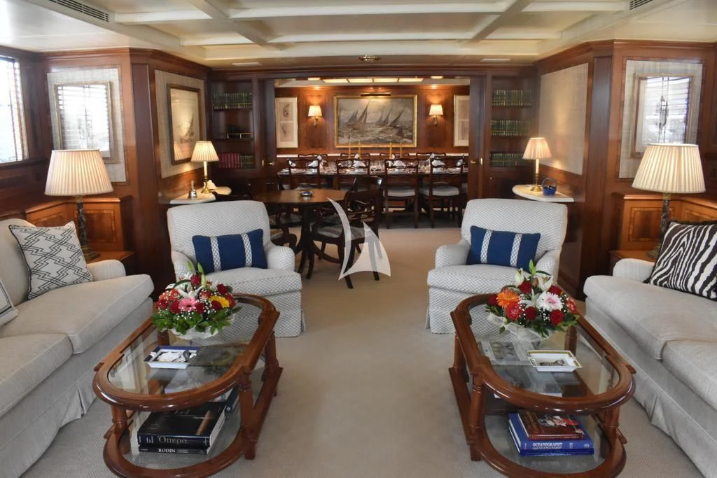 a living room with a large table and chairs aboard OKTANA Yacht for Sale