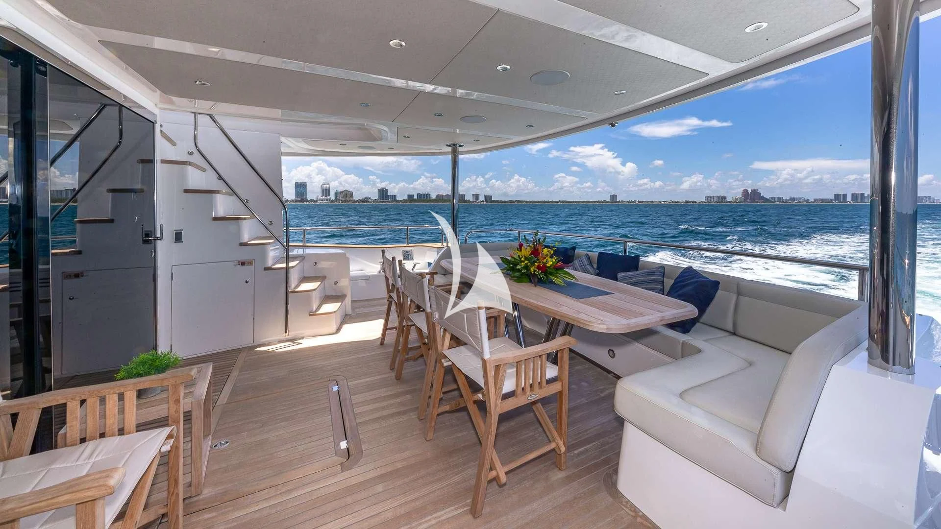 a room with a table and chairs aboard MIRRACLE Yacht for Sale