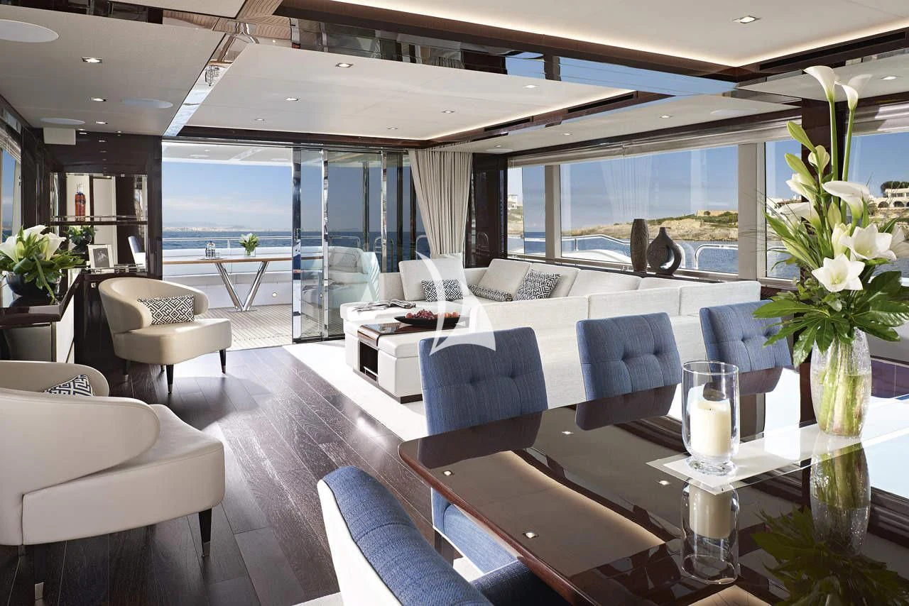 a room with a table chairs and a vase with flowers in it aboard MIRRACLE Yacht for Sale