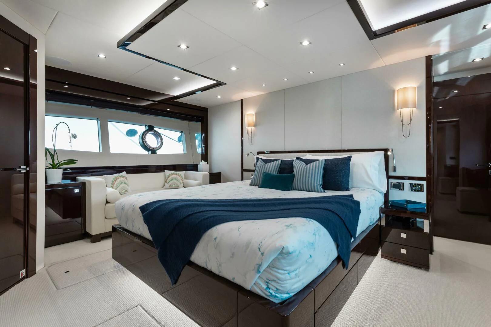 a bedroom with a bed and a desk aboard MIRRACLE Yacht for Sale