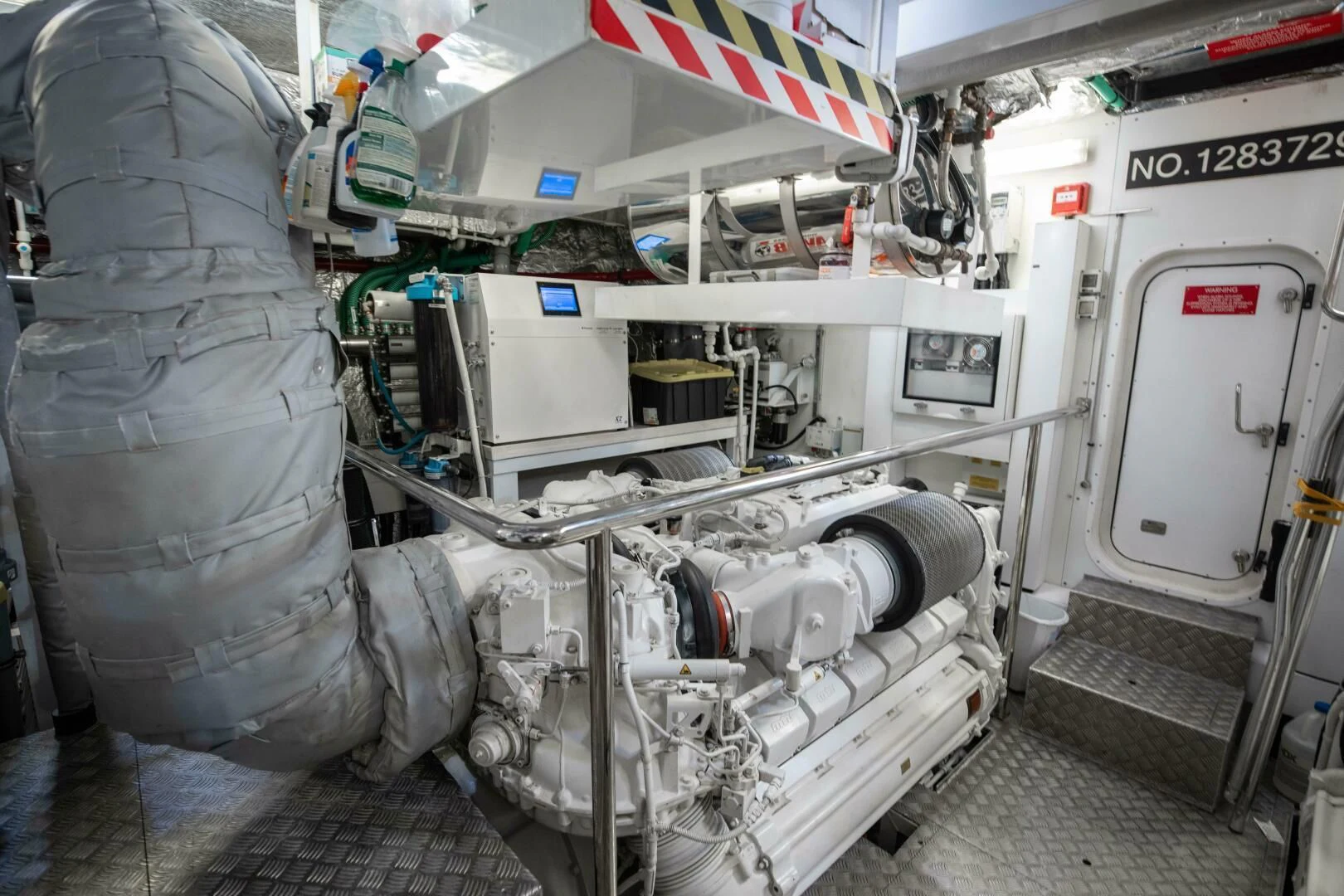 a person in a grey jacket standing next to a white machine aboard MIRRACLE Yacht for Sale