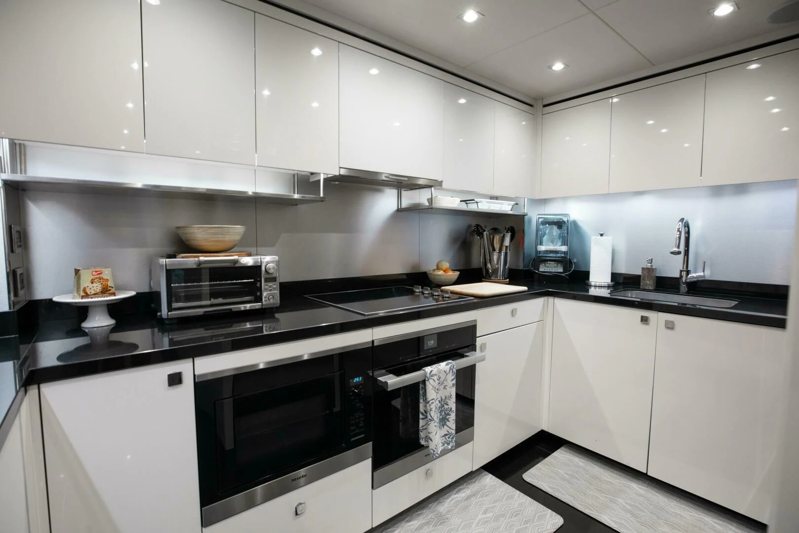 a kitchen with white cabinets aboard MIRRACLE Yacht for Sale
