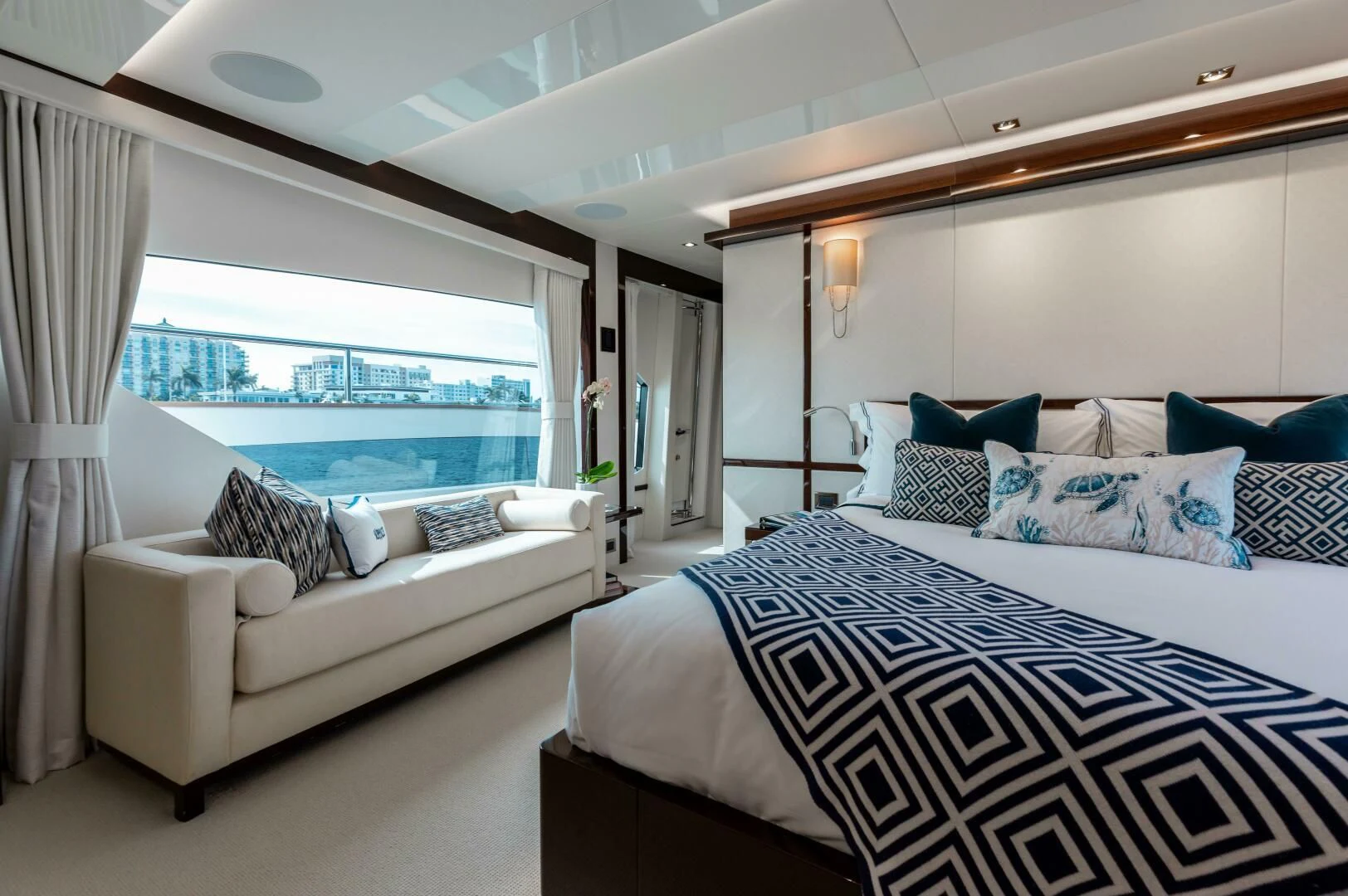 a bedroom with a large bed aboard MIRRACLE Yacht for Sale