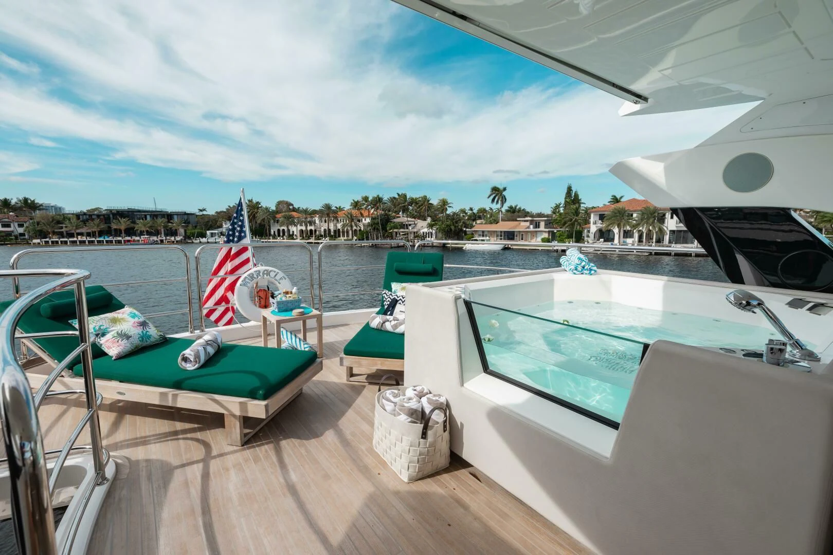 a deck with a pool and a deck with a flag on it aboard MIRRACLE Yacht for Sale