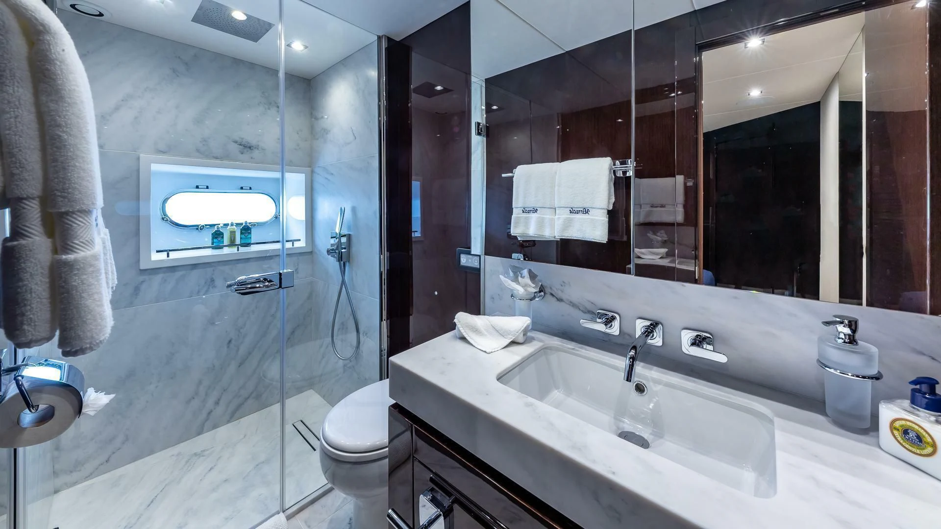 a bathroom with a large mirror aboard MIRRACLE Yacht for Sale