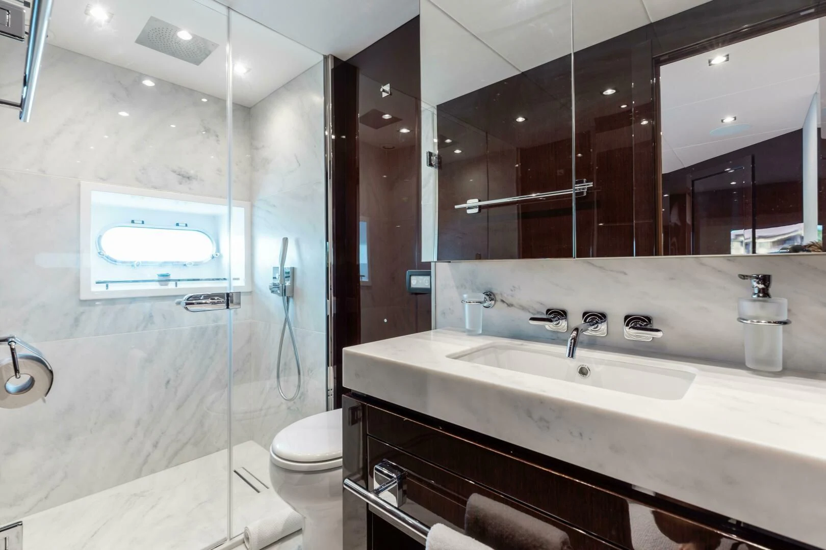 a bathroom with a large mirror aboard MIRRACLE Yacht for Sale