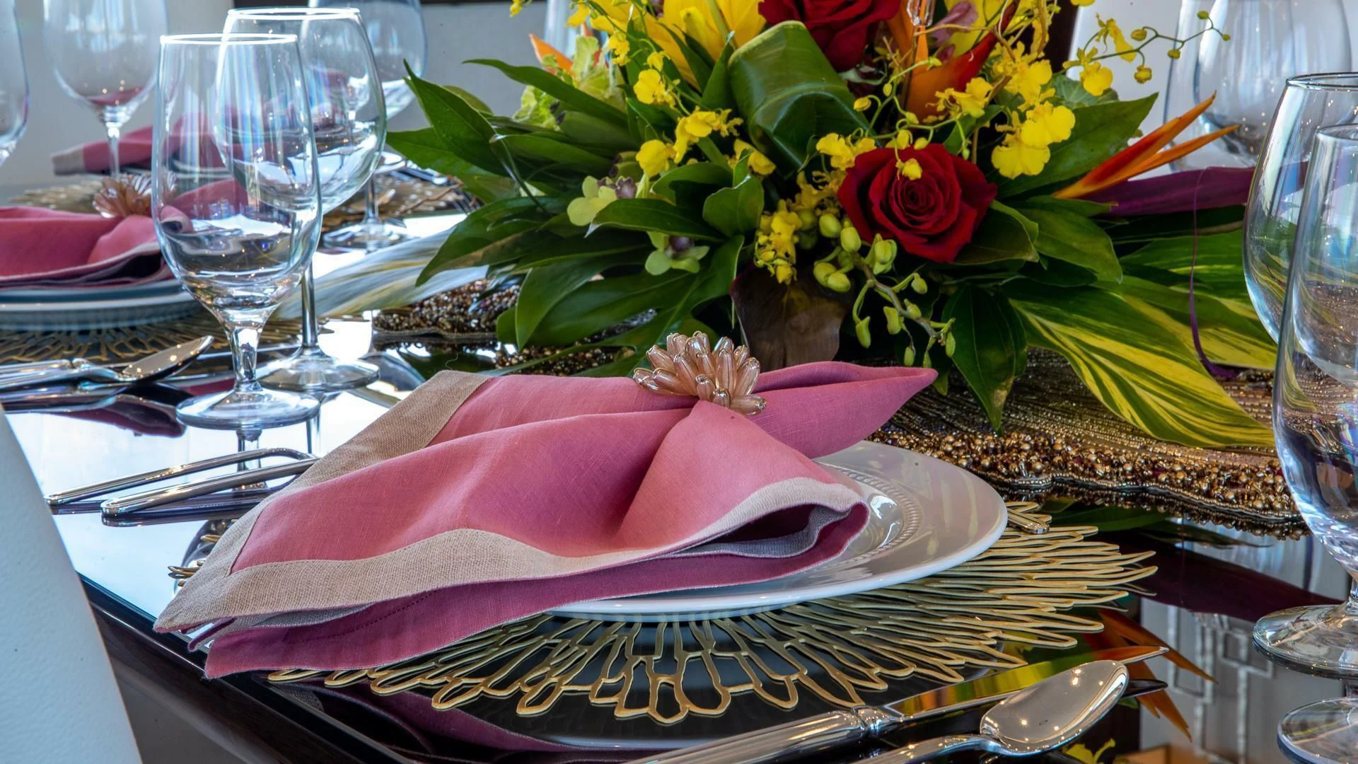 a table with a plate of food and glasses on it aboard MIRRACLE Yacht for Sale