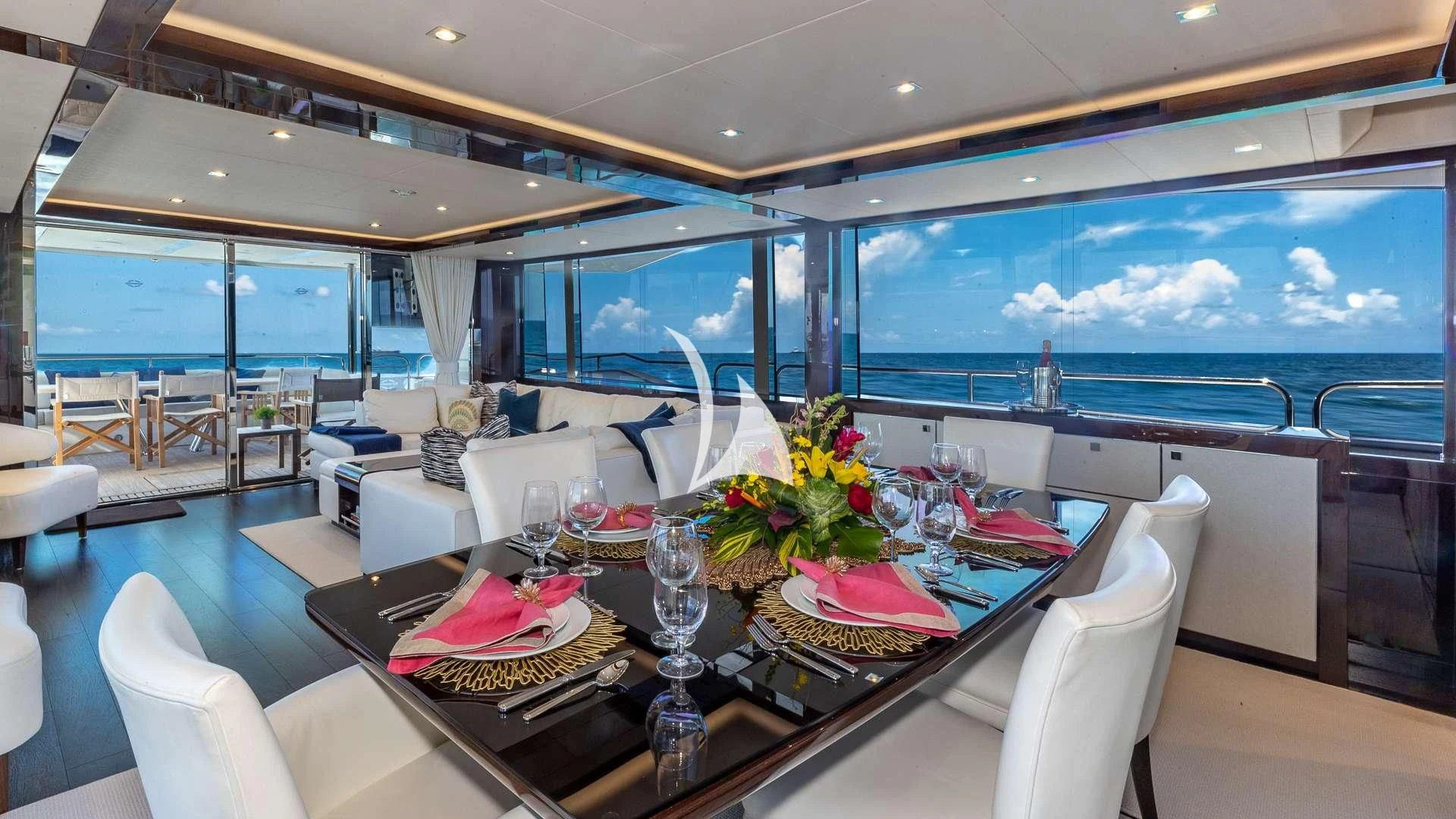 a dining room with a large window aboard MIRRACLE Yacht for Sale