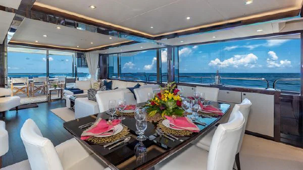 a dining room with a large window aboard MIRRACLE Yacht for Sale