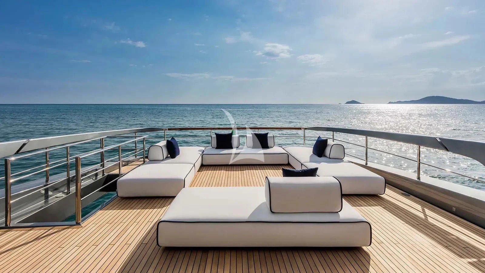 a deck with chairs and a body of water in the background aboard DON'T WORRY Yacht for Sale