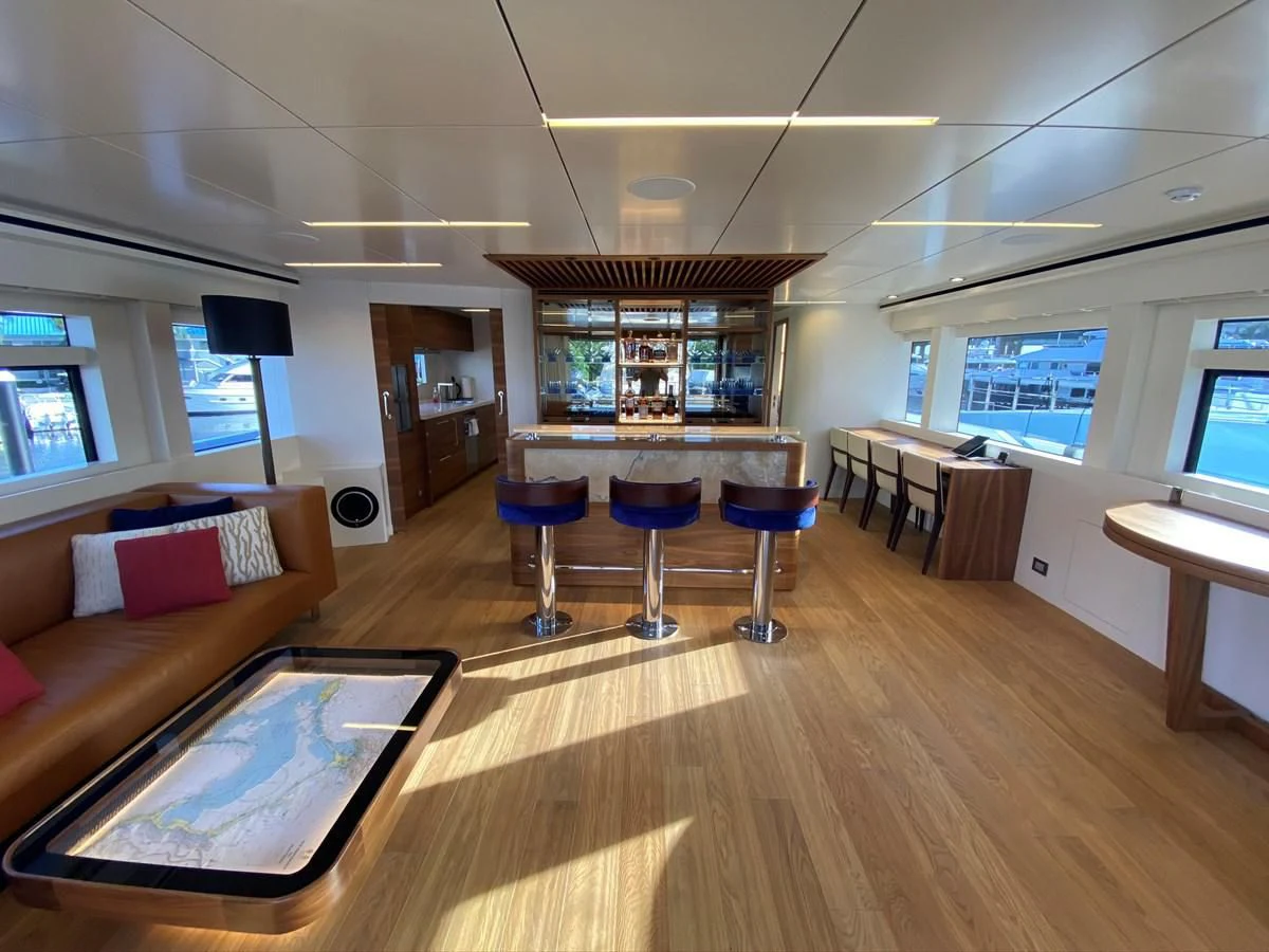 a living room with a wood floor aboard PERSISTENCE Yacht for Sale