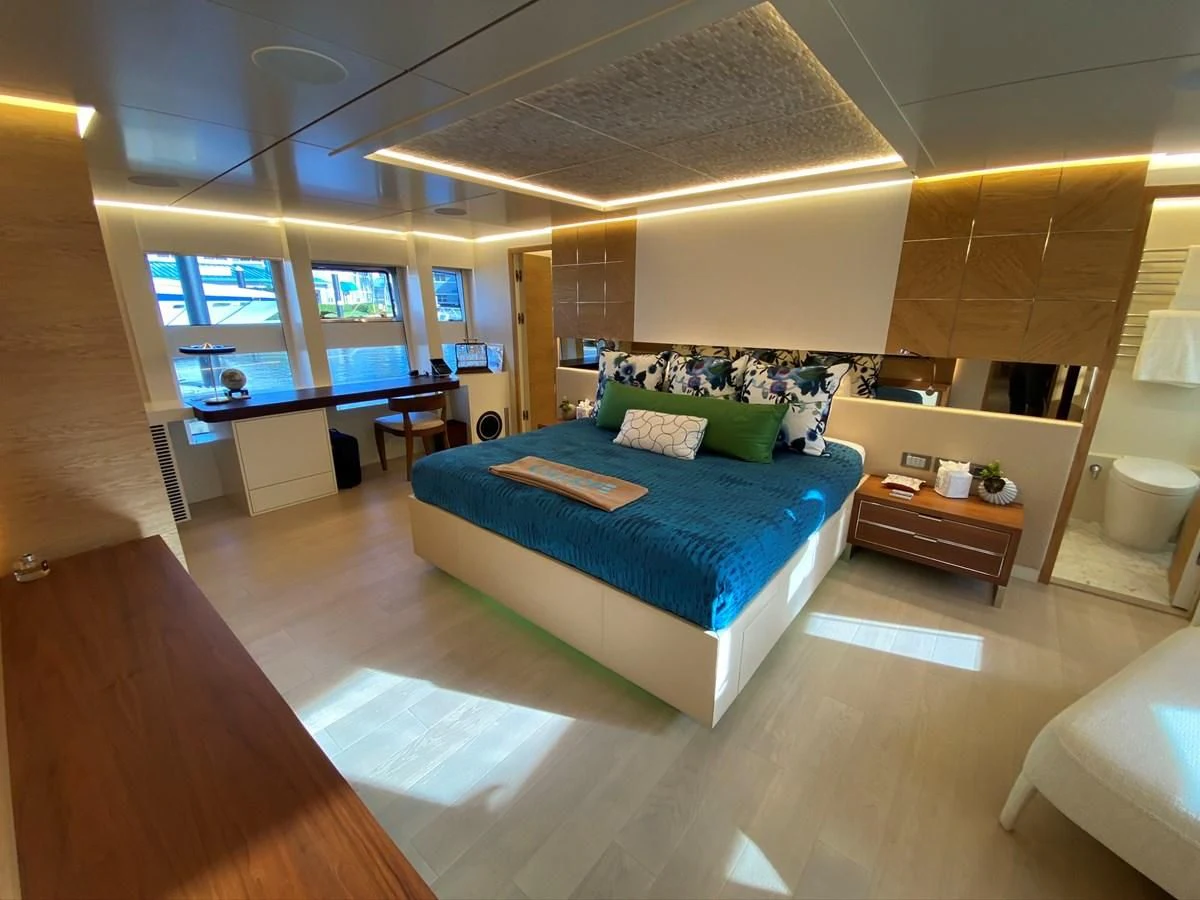 a room with a bed and a desk aboard PERSISTENCE Yacht for Sale