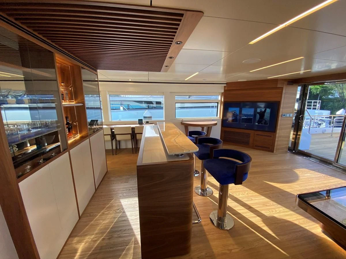 a room with a desk and chairs aboard PERSISTENCE Yacht for Sale
