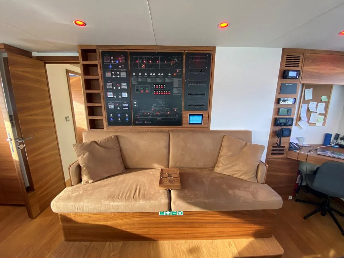 a living room with a couch aboard PERSISTENCE Yacht for Sale