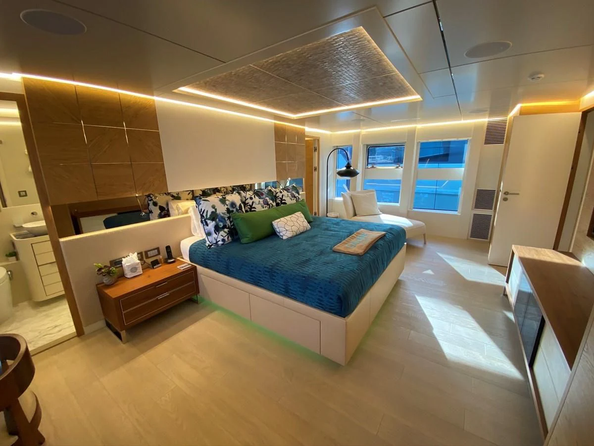 a bedroom with a bed and a desk aboard PERSISTENCE Yacht for Sale