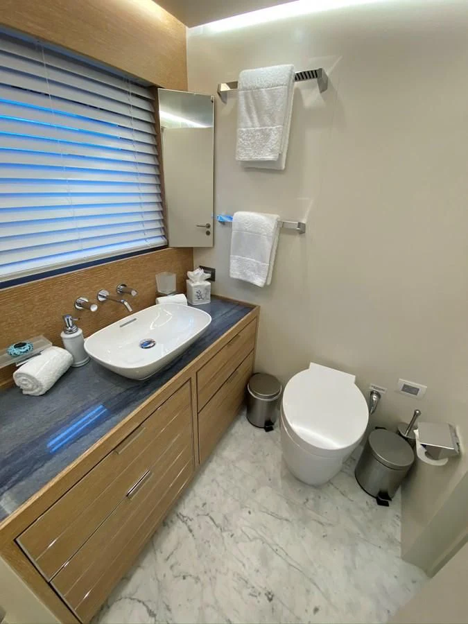 a bathroom with a sink toilet and a window aboard PERSISTENCE Yacht for Sale