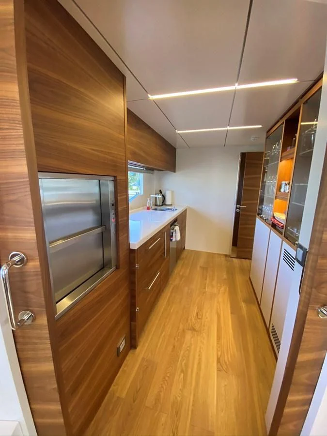 a kitchen with wooden cabinets aboard PERSISTENCE Yacht for Sale