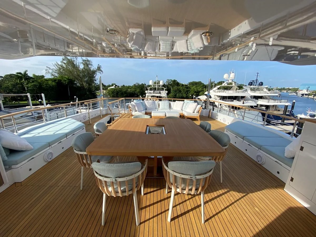 a table and chairs on a deck aboard PERSISTENCE Yacht for Sale
