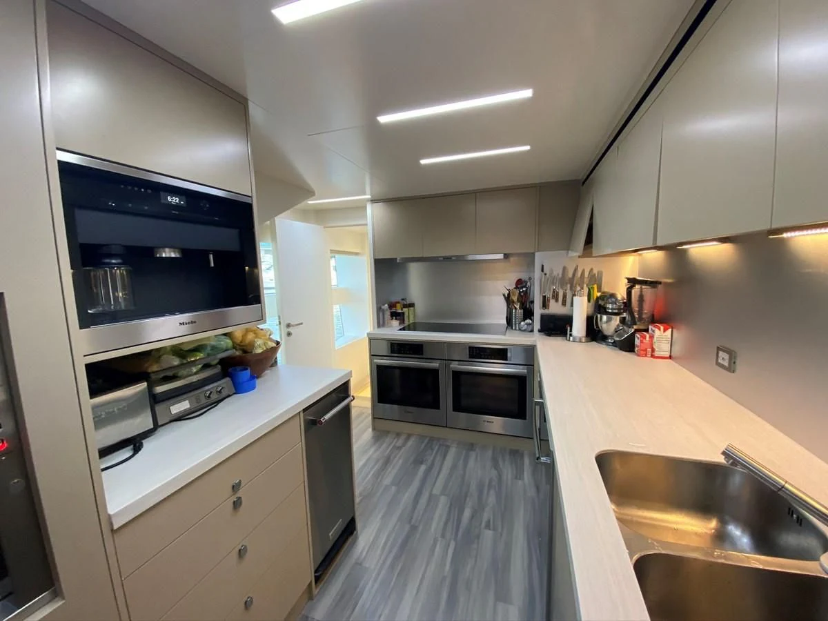 a kitchen with white cabinets aboard PERSISTENCE Yacht for Sale